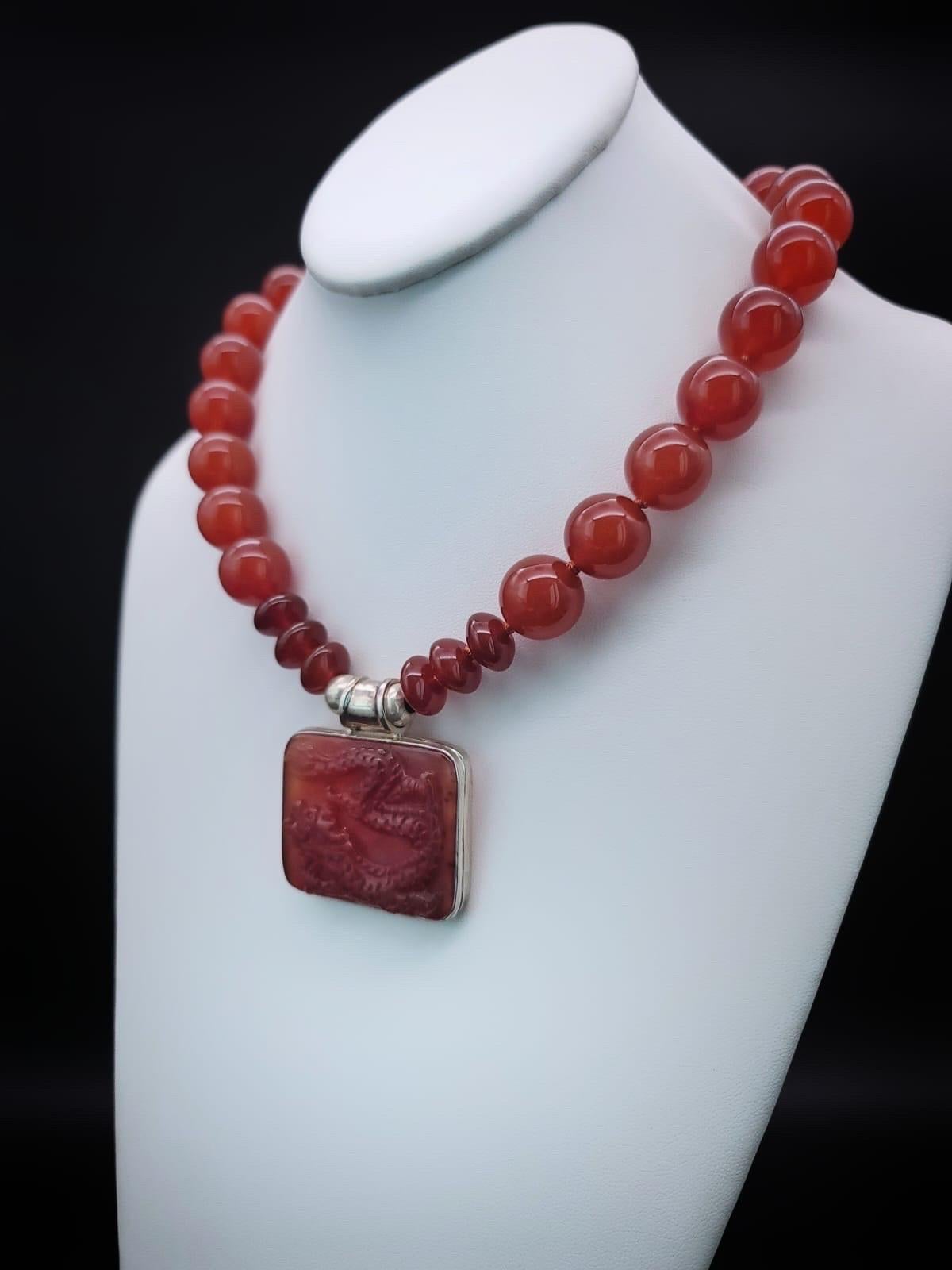One-of-a-Kind

Richly colored 18m.m. Carnelian gemstone necklace. The red Carnelian pendant suspended from the necklace is a 2”x11/2 Carnelian Dragon richly carved into the stone. The dragon symbol of the emperor in China is particularly powerful