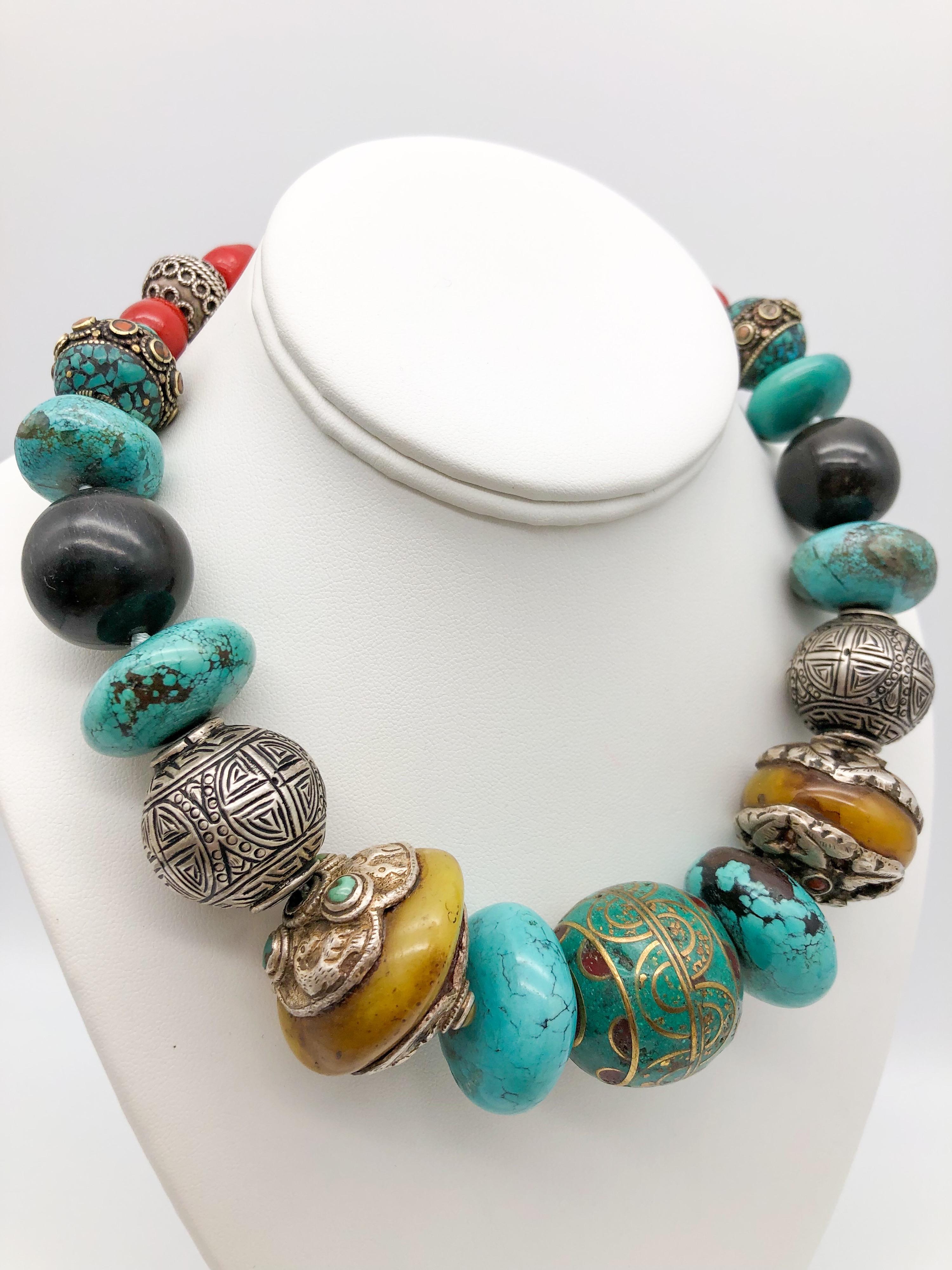 
One-of-a-Kind
Bold necklace with a large center bead of Tibetan, Cloisonné surrounded by Tibetan Silver and Amber beads large turquoise discs, Onyx beads, Red Chinese stones, Sterling Silver beads, Tibetan beads  inlaid with turquoise . The box