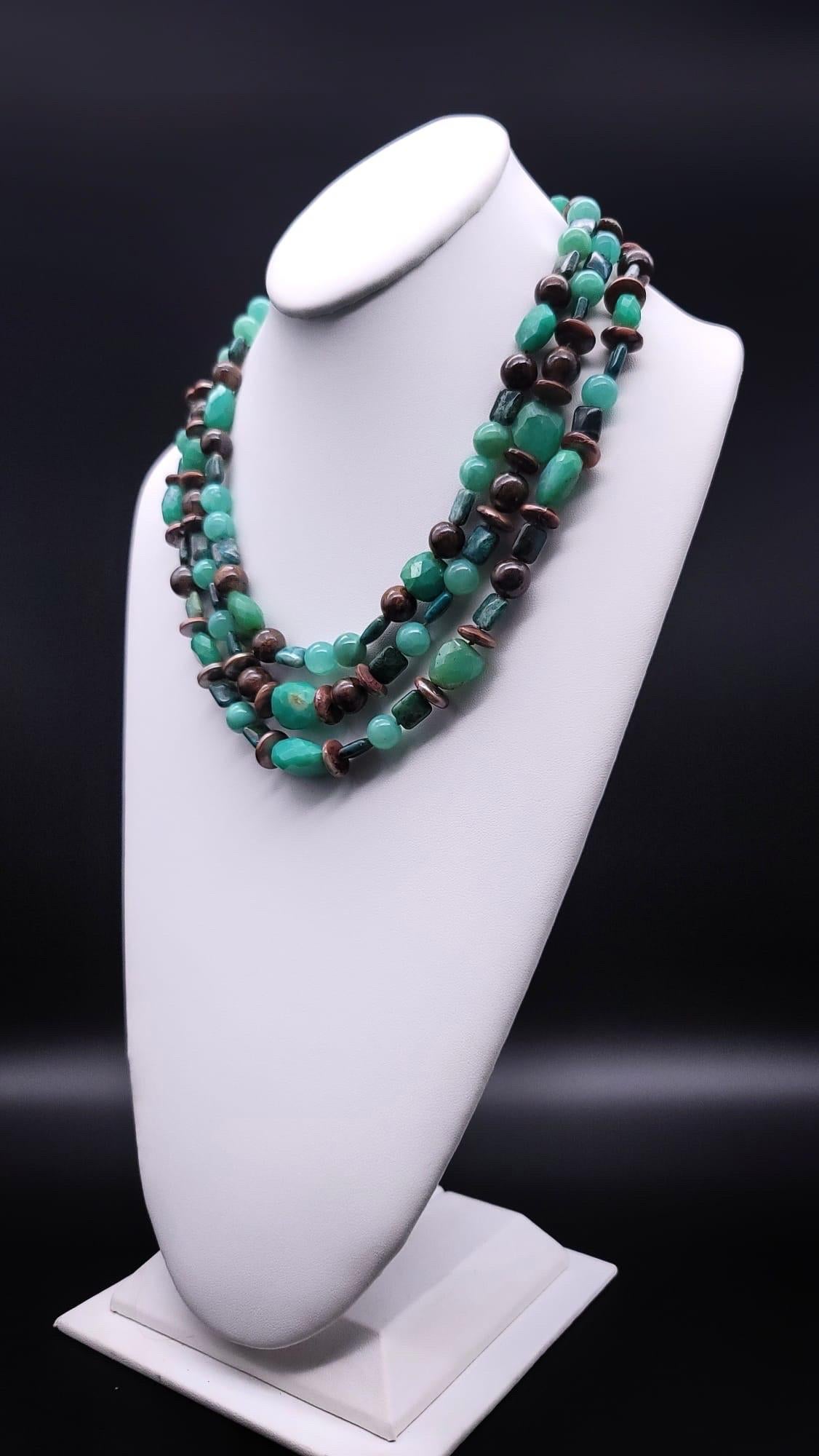 One-of-a-Kind

A veritable ragout of Chrysoprase stones in multiple cuts( faceted, polished )hues( brightest green to grass green to soft green) mixed with deep Australian brown Opal, as well as center drilled bronze Pearls, in a nested three-strand