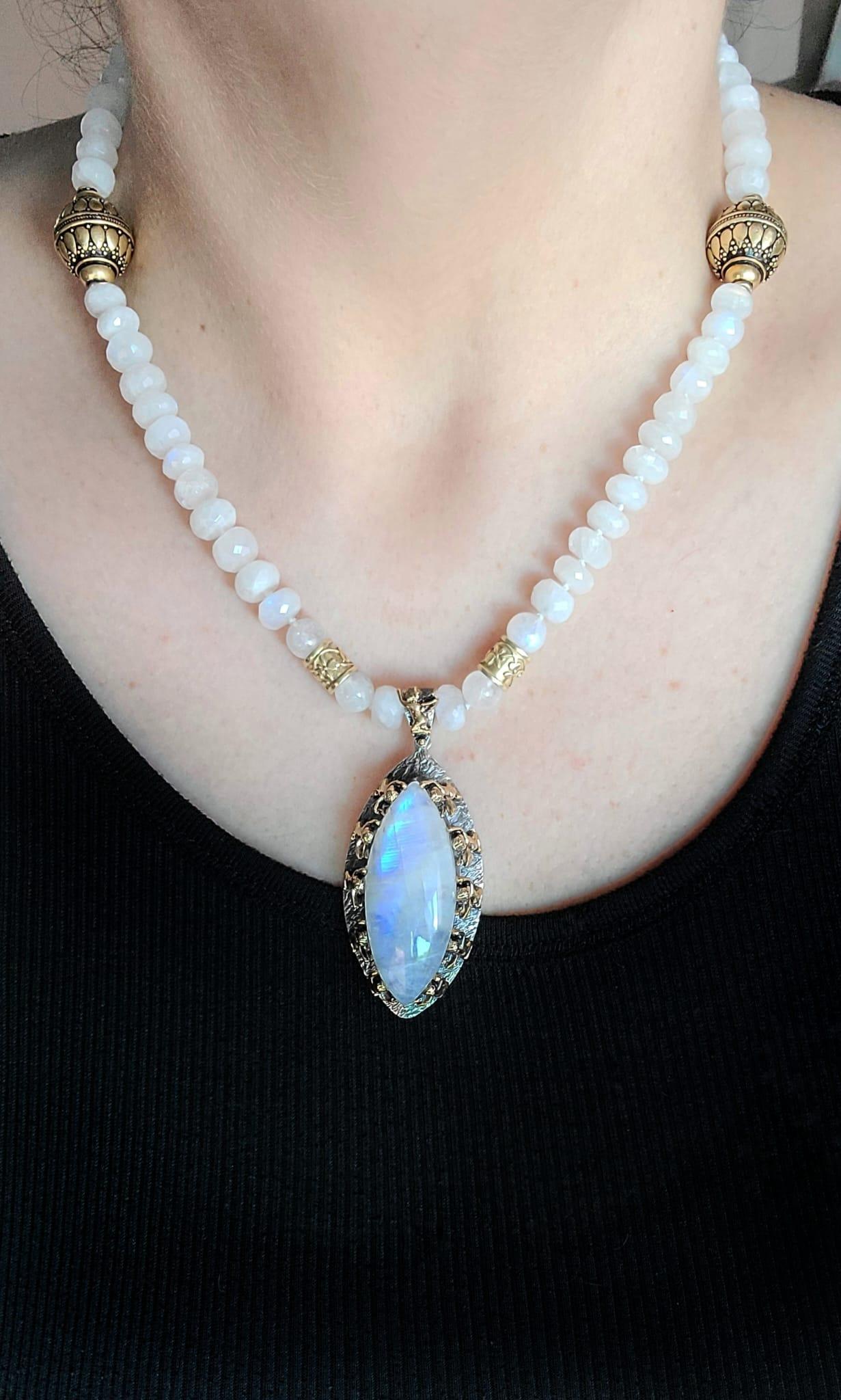 One-of-a-Kind

Rainbow Moonstone is set in a beautiful Bora hand-crafted  sterling and bronze pendant . 
The large polished moonstone is supported by ten cherubs who surround it. The bezel that holds
the necklace is one last cherub. The necklace is