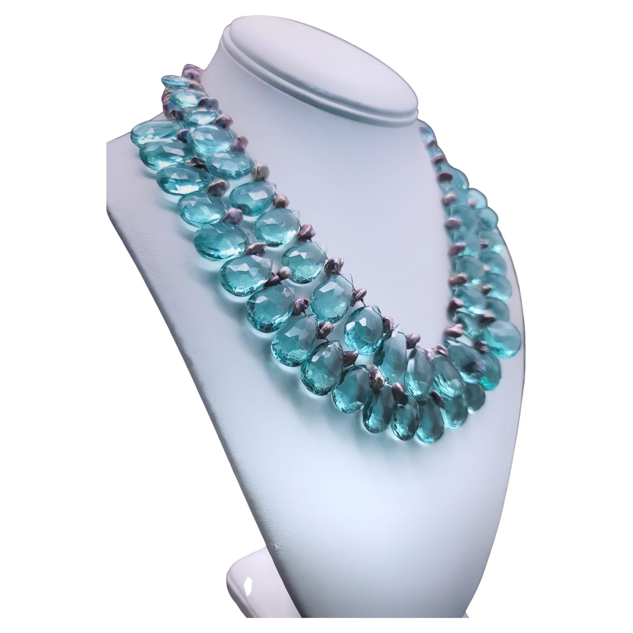 One-of-a-Kind

Romantic 2-strand hand-knotted Blue Quartz necklace. The richly colored, faceted, teardrop Quartz is accented by equally rich colored pinky/ bronze small baroque pearls. The clasp is fashioned from a vintage cuff link intaglio horse