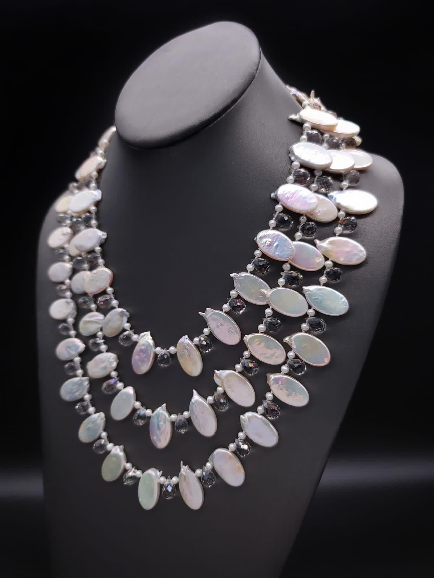 One-of-a-Kind

Think of making an entrance (or walking down an aisle ) in a romantic 3-strand mixed Pearl necklace.  Large, luminous petal pearls, separated by clusters of seed pearls and crystal teardrops.
The clasp is a coin pearl set in sterling