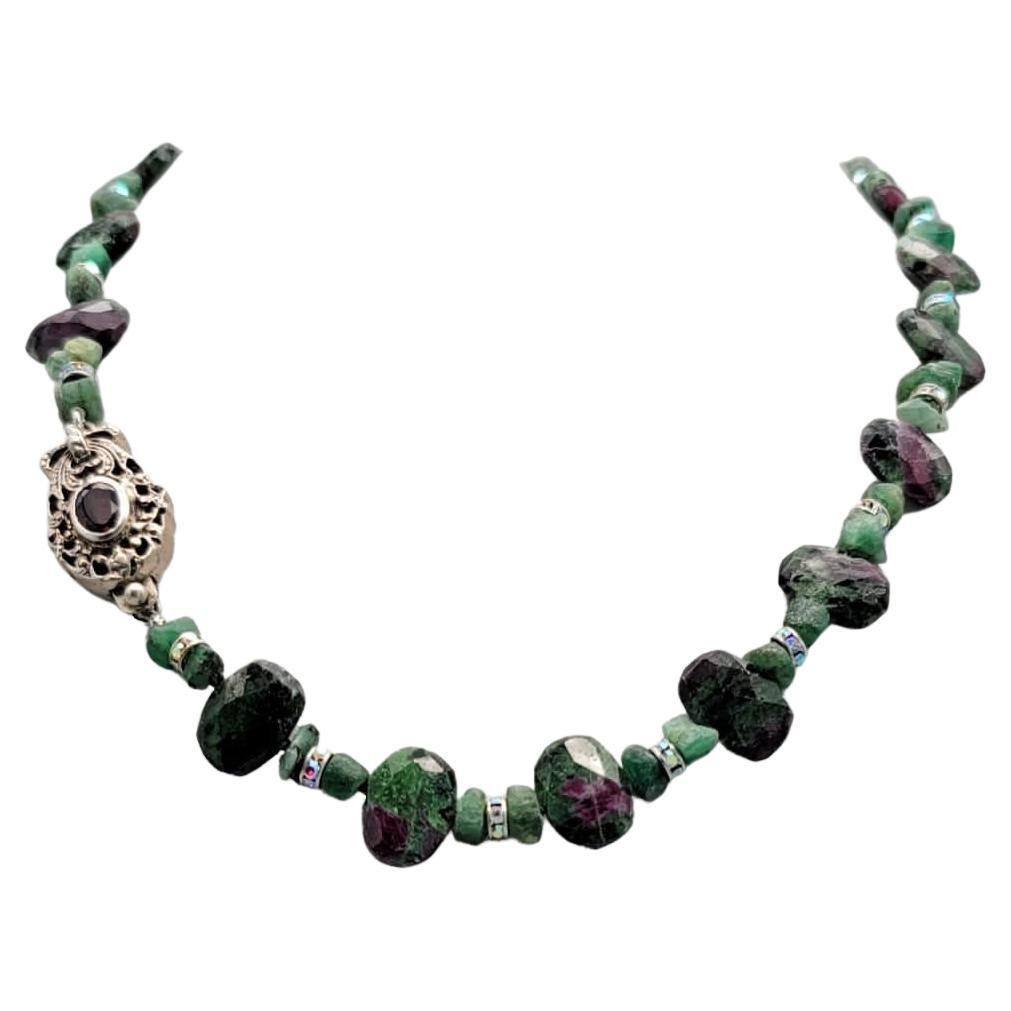 One-of-a-Kind

Ruby in zoisite and emerald, a delicate necklace delivering a big punch.
The necklace is composed of faceted Ruby in Zoisite, an unusual stone of natural Ruby crystals embedded in green Zoisite. The stone was first discovered in 1954.