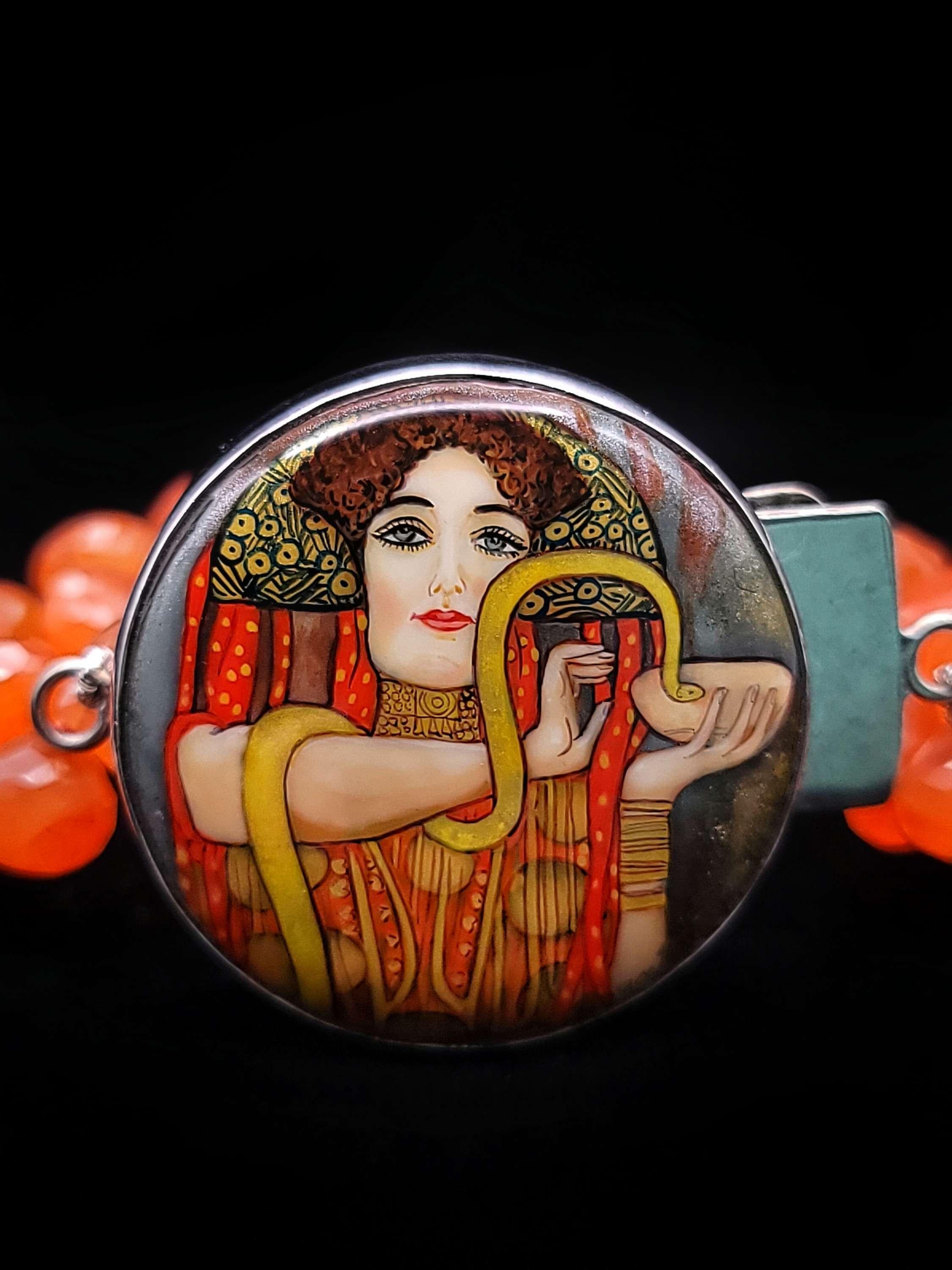 This one-of-a-kind bracelet designed by Elaine Silverstein is a stunning work of art that showcases the beauty and craftsmanship of Russian miniaturists. The centerpiece of the bracelet is a carefully reduced rendition of Gustav Klimpt's 