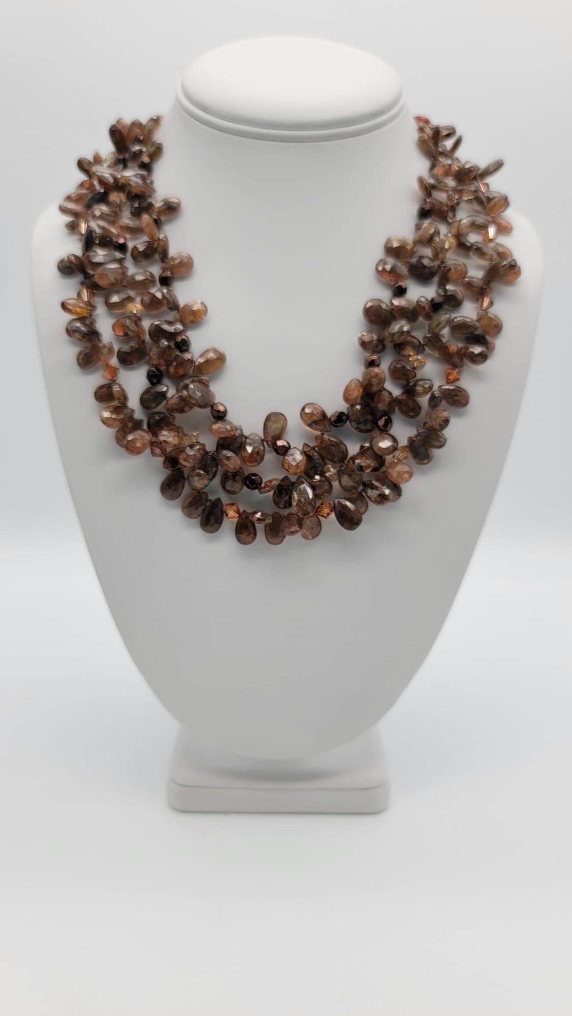 One-of-a-Kind

Stop the show with this glamorous 3-strand teardrop polished and faceted, brown Rutilated Quartz and Sunstone necklace. The clasp, which looks great on the side as well, is a beautiful piece of polished Picasso jasper set in sterling