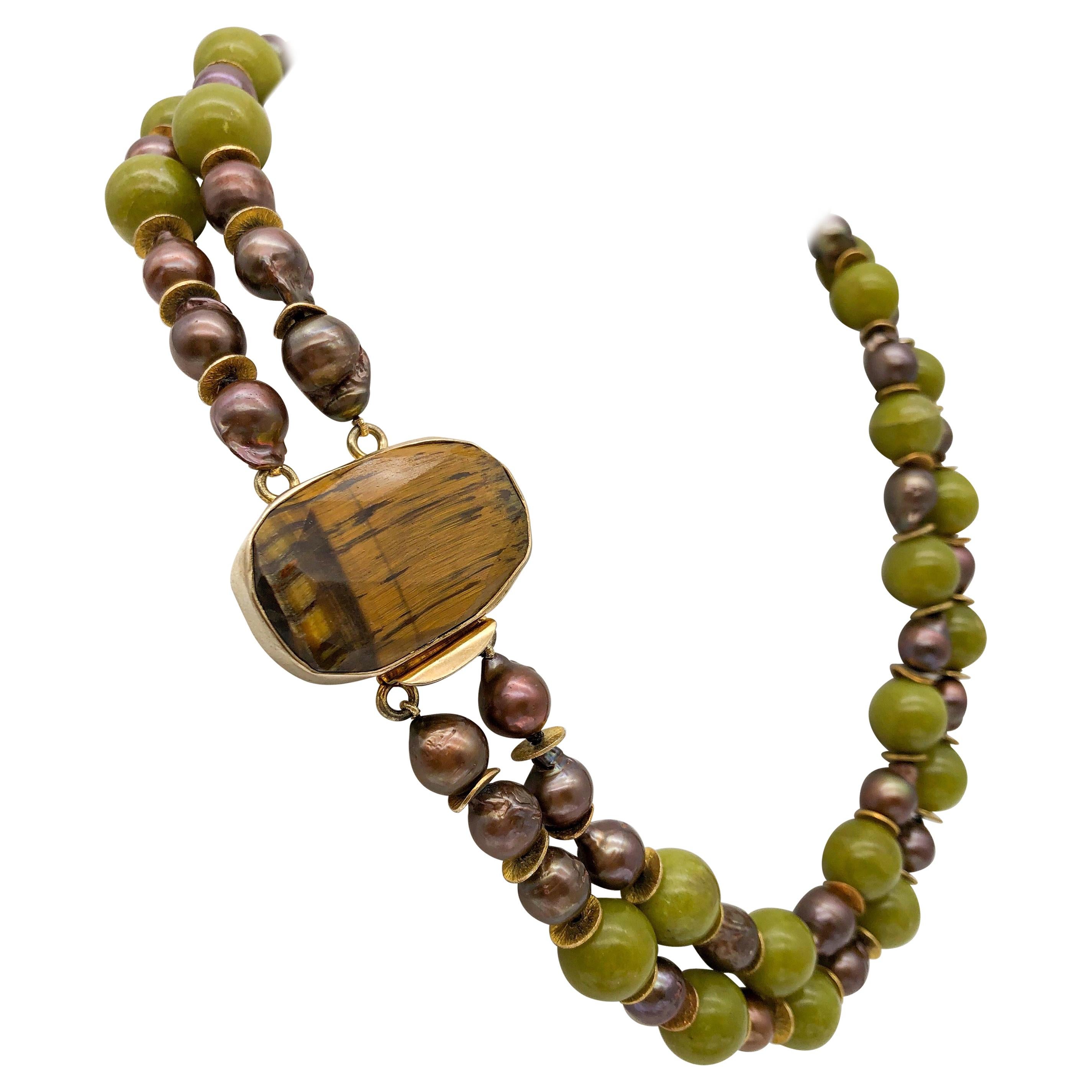 One-of-a-Kind
Two strand Beautiful Polished green olive Jade beads are hand-knotted with matching silk cord and spaced with Chocolate Freshwater Pearls and vermeil. Faceted Tigers Eye setting in a Signature Vermeil clasp.
Approx: 20 inch
 