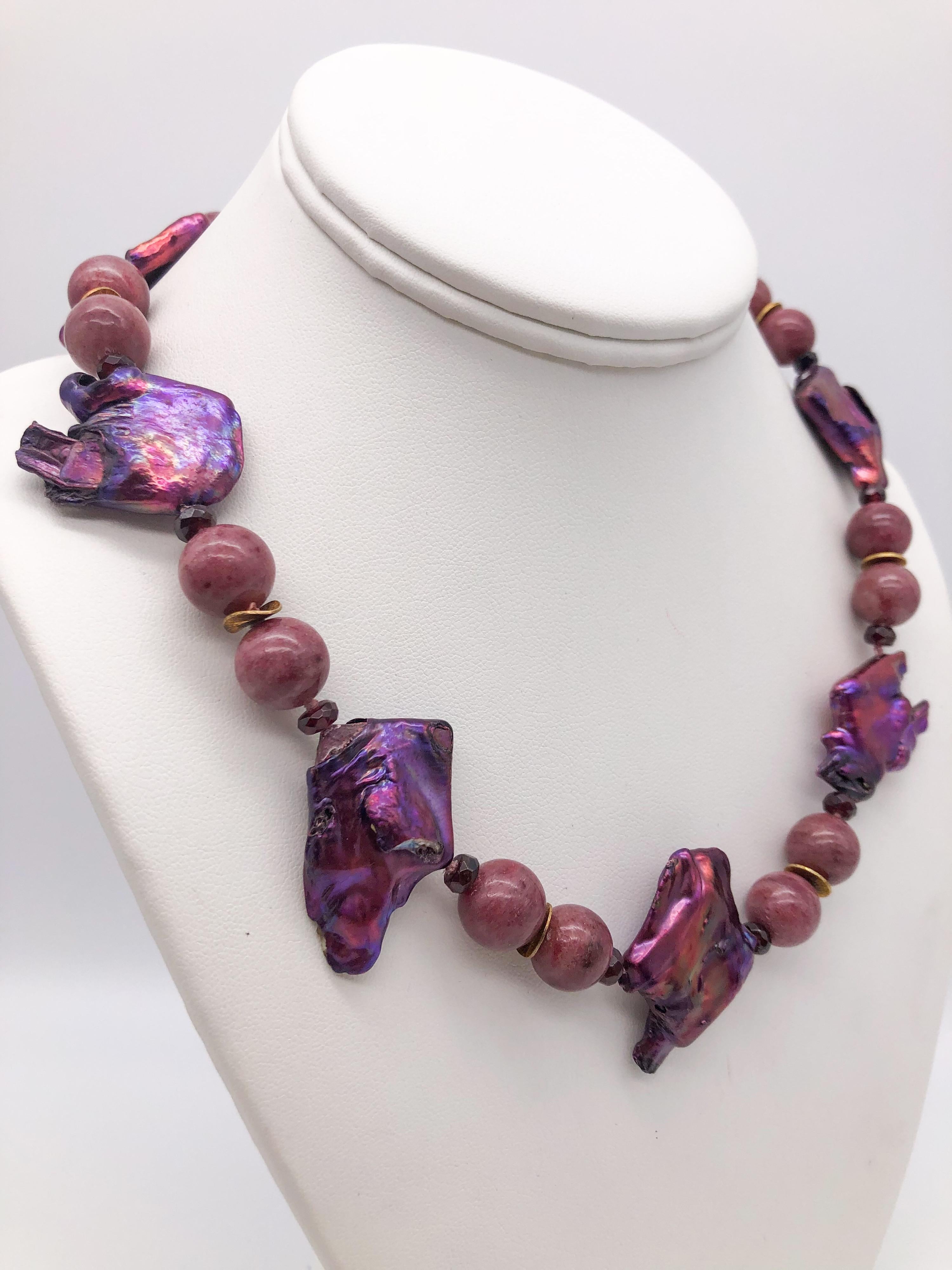 One-of-a-Kind
A study in magenta. These unusually large and deep-hued pearls with other beads in the same range of colors, both zoisite, and garnet, make a highly attractive one-of-a-kind presentation. The clasp is a traditional Navaratna. The 9 gem