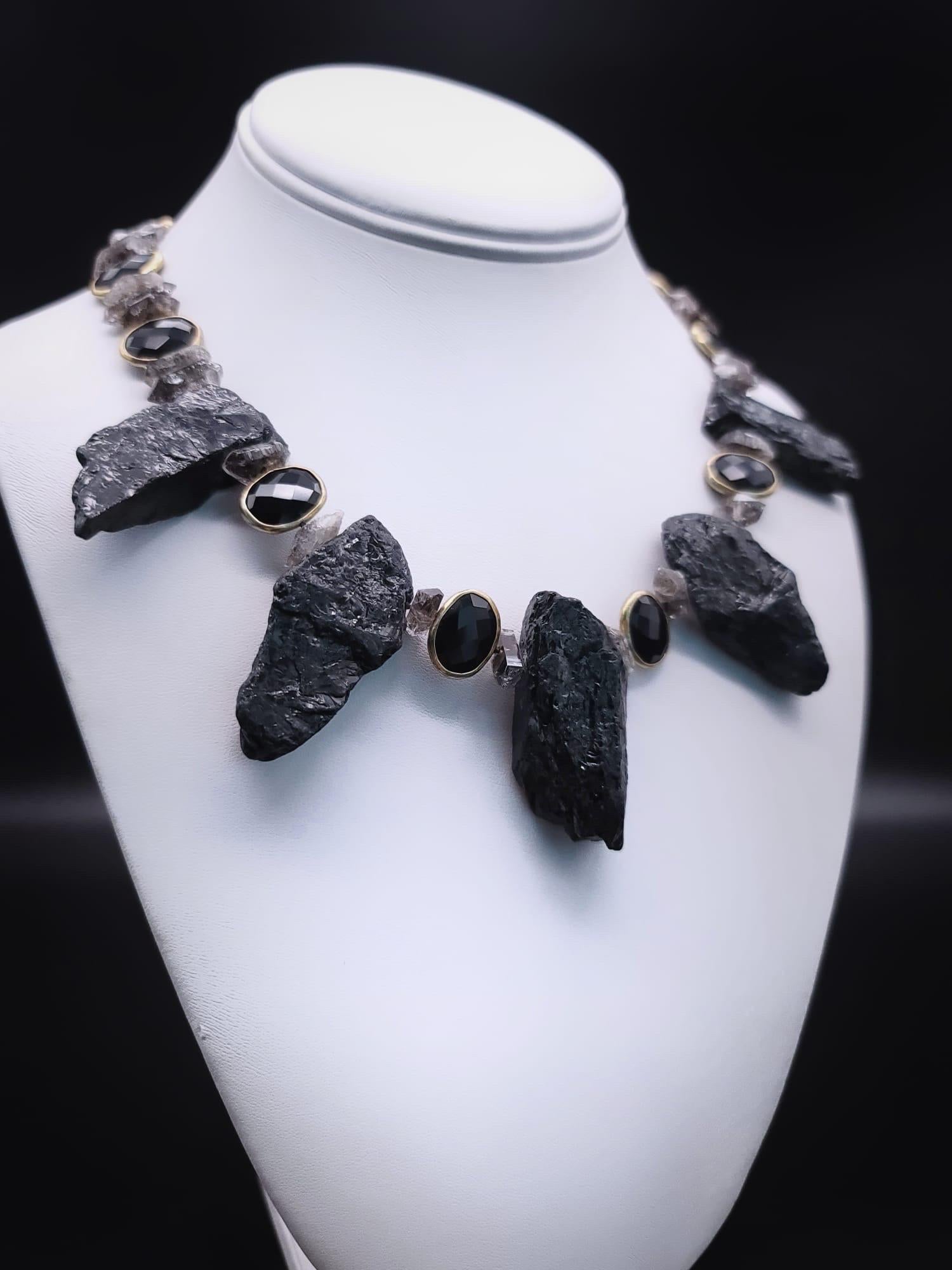 One-of-a-Kind

 A necklace as strong and powerful as you are. Large nuggets of rough cut and polished black tourmaline and crystal tourmaline are carefully selected to create a one-of-a-kind piece that exudes strength and confidence. The faceted