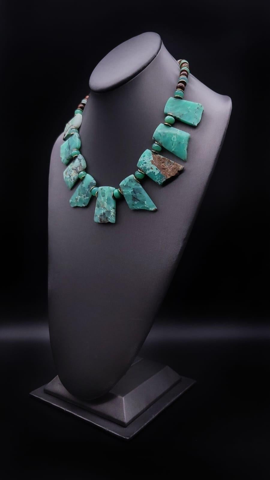 Behold, a truly unique marvel: an Australian Chrysoprase necklace that captures the essence of nature's splendor. At its core, a bib of hand-cut and polished stones forms a striking focal point, suspended gracefully from a strand of polished