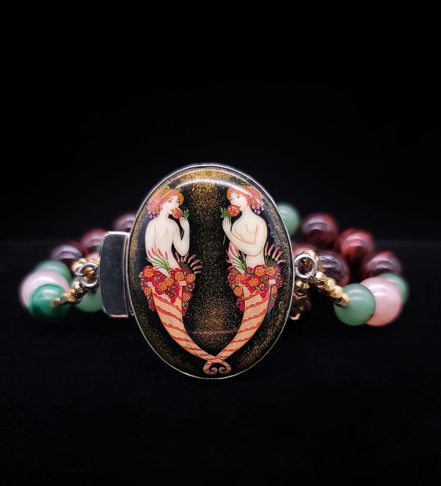 One-of-a-Kind

3 strand mixed red tiger’s eye, morganite, and green jade 10- 12 mm bead bracelet surrounds a hand-painted clasp. The clasp is Sterling silver and was painted in a Russian atelier by the same craftsman/ artists who provide the world