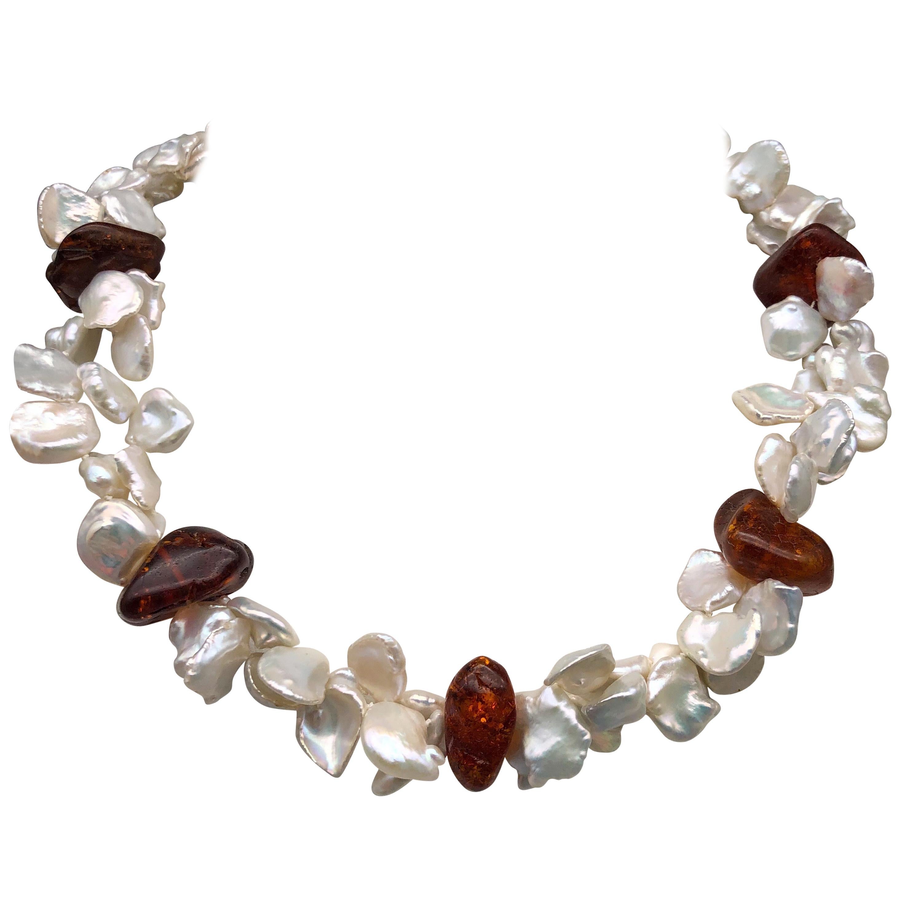  Unique One-of-a-Kind Keshi Pearl and Baltic Amber Necklace - a piece of jewelry that is sure to turn heads and capture attention wherever you go. This stunning necklace features a double strand of beautiful Keshi Pearls, perfectly matched and