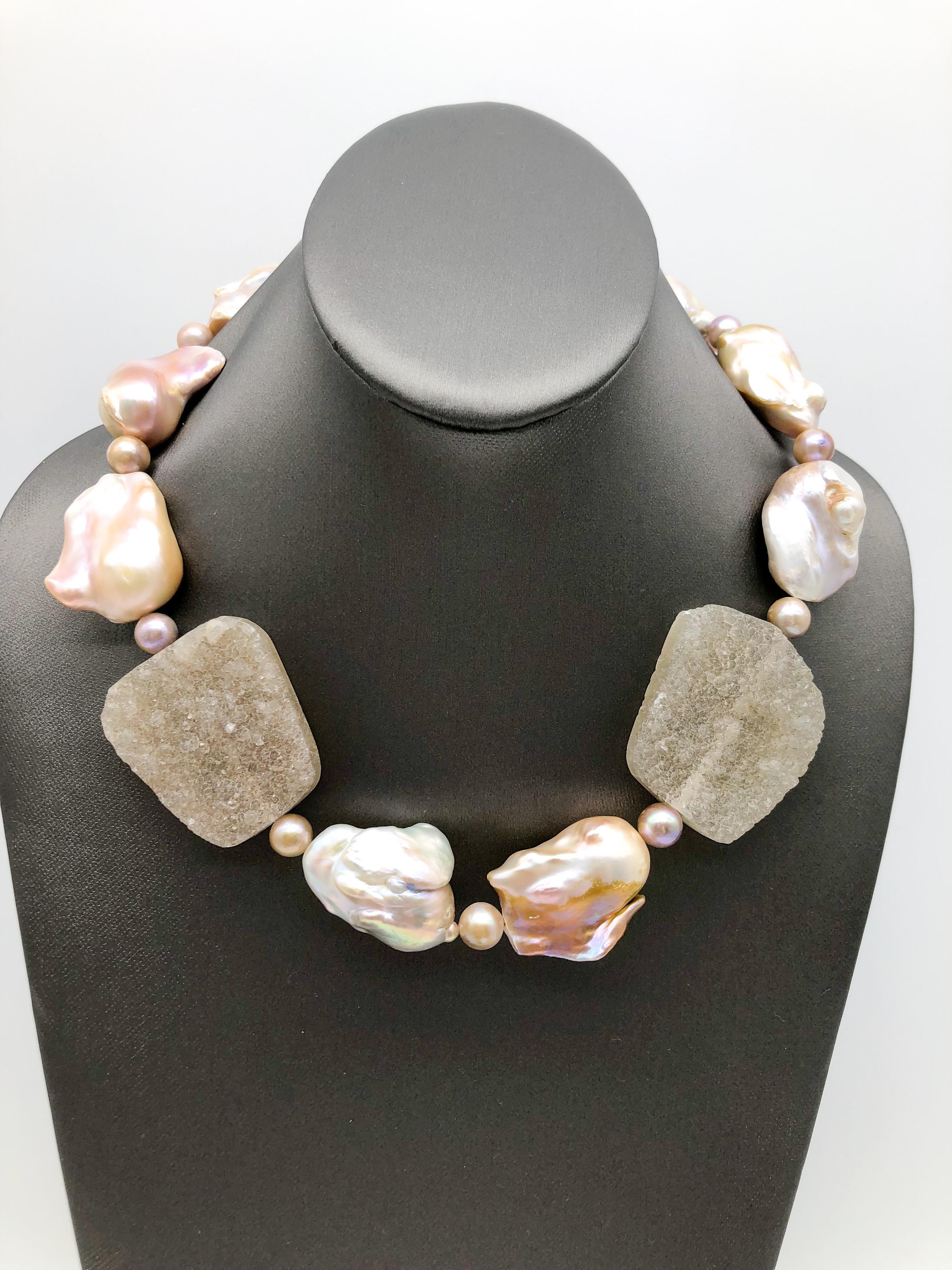 One-of-a-KInd

Make a statement in a dramatic pink Baroque Pearl and Brazilian Druzy single strand necklace. What is so eye-catching about this piece is the size and quality of each stone. Separated by 8mm Pearls there are only 10 huge stones each