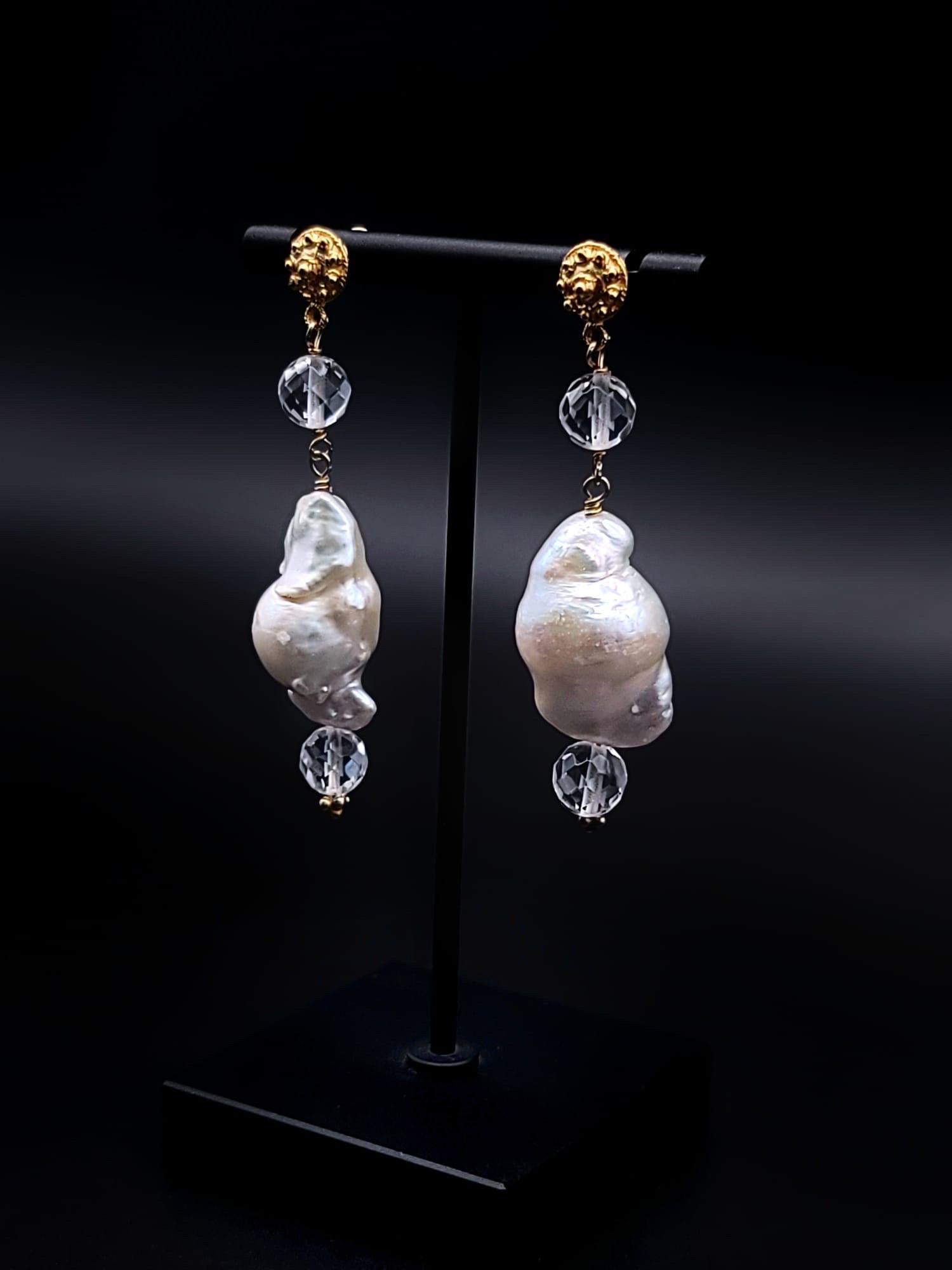 One-of-a-Kind

These stunning Pearl and Crystal drop earrings exude elegance and charm. The pair of large Baroque white lustrous Pearls are suspended from a cut crystal bead, creating a beautiful and graceful silhouette. The handcrafted vermeil