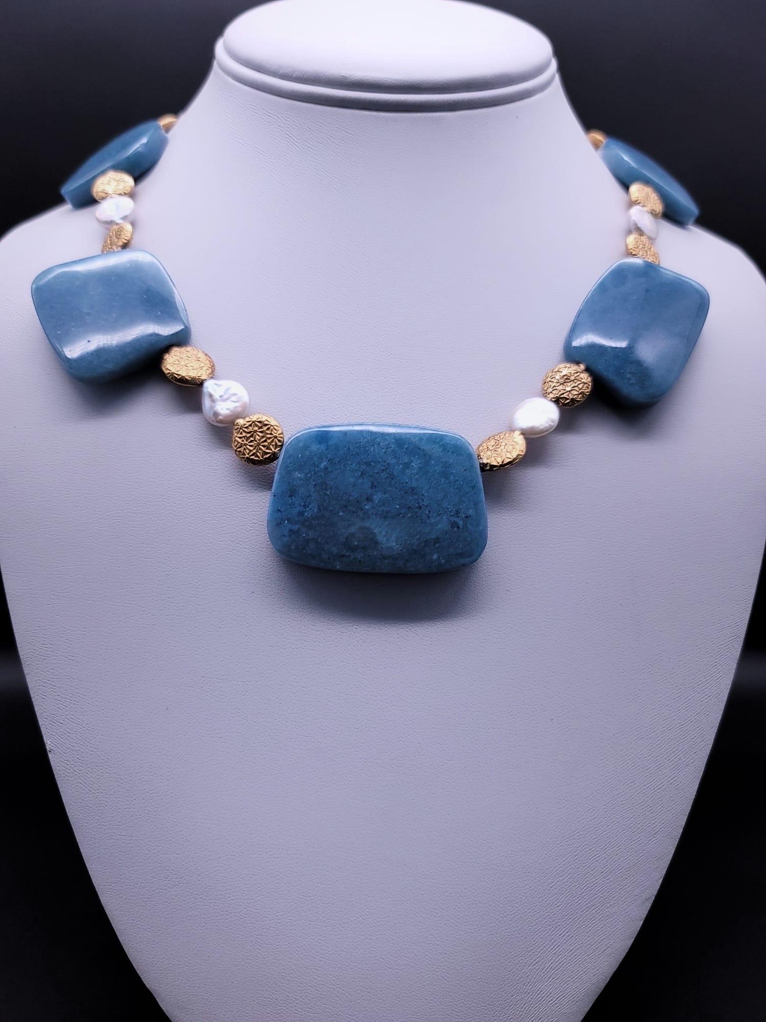 One-of-a-Kind

Rich French Blue Quartz polished plates separated by hand tooled vermeil beads and flat coin freshwater pearls matched in size . The components combine in a 17” necklace. The  clasp is vermeil  with a dragonfly alight the carved
