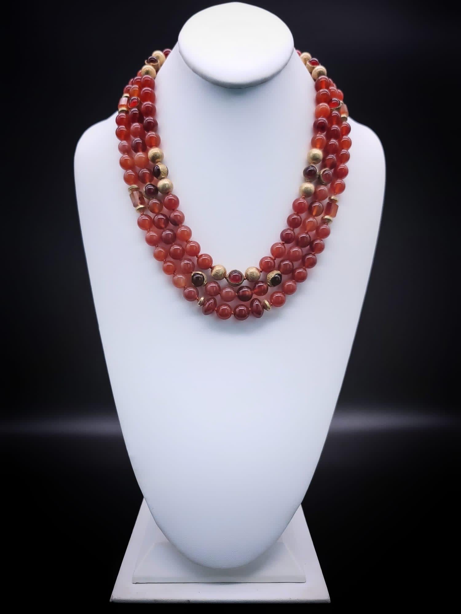 One-of-a-Kind

Take control in a power necklace.
3 strands of polished 10 m.m polished Carnelian translucent beads. Accented with brushed vermeil gold beads, as well as Carnelian beads that have been encircled by vermeil. The interesting clasp is a