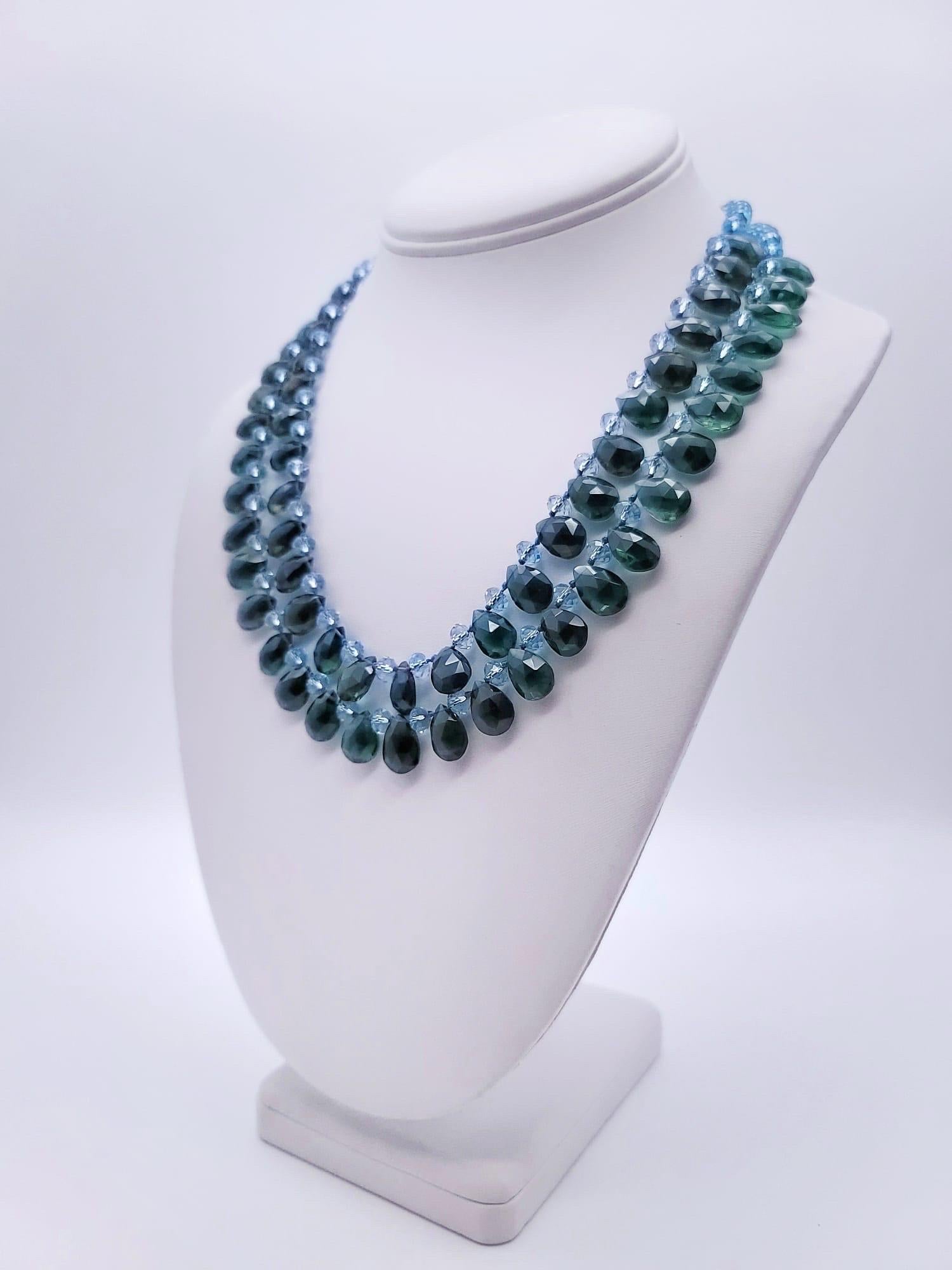 One-of-a-Kind

A whimsical mix of dark Emerald Green Quartz teardrops mixed with faceted Blue Topaz rondels merges into two sparkling strands to make a glamorous statement. The clasp is a large faceted Blue Topaz set in vermeil.

Blue topaz promotes