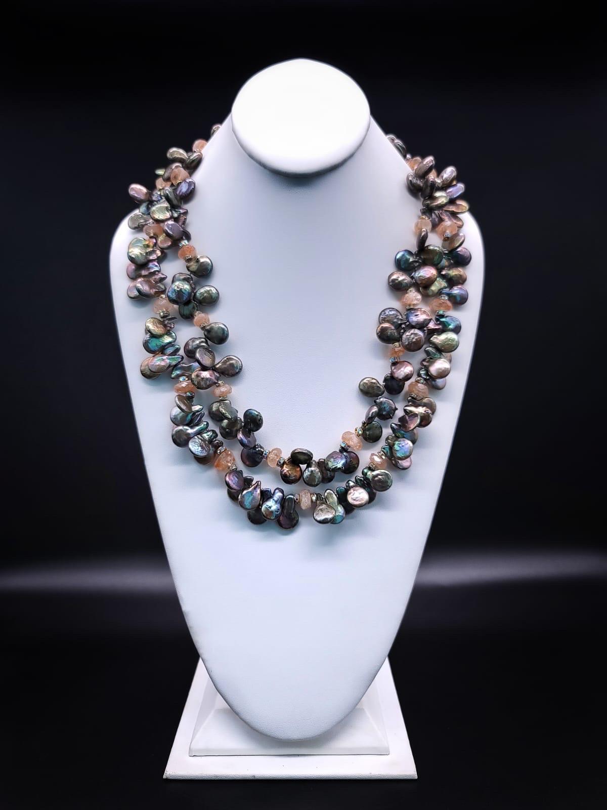 One-of-a-Kind

Indulge in timeless elegance with this exquisite two-strand lustrous top drilled necklace of gray pearl with an intriguing hand painted Russian miniature clasp. The pearl necklace is accented with faceted, softly colored, faceted