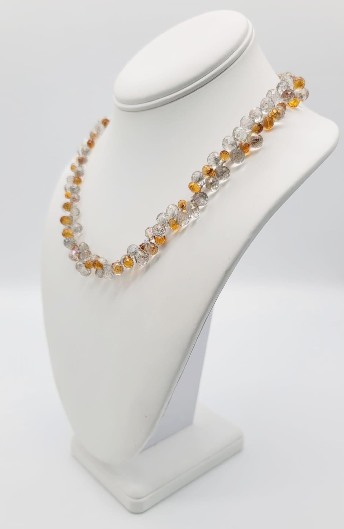 One-of-a-Kind

Topaz and crystal Quartz faceted teardrops dance together in a feminine, sparkly, face-flattering necklace,
It is like a beam of sunshine (or your personal spotlight ) at your throat. The clasp is a boxed sterling silver with a