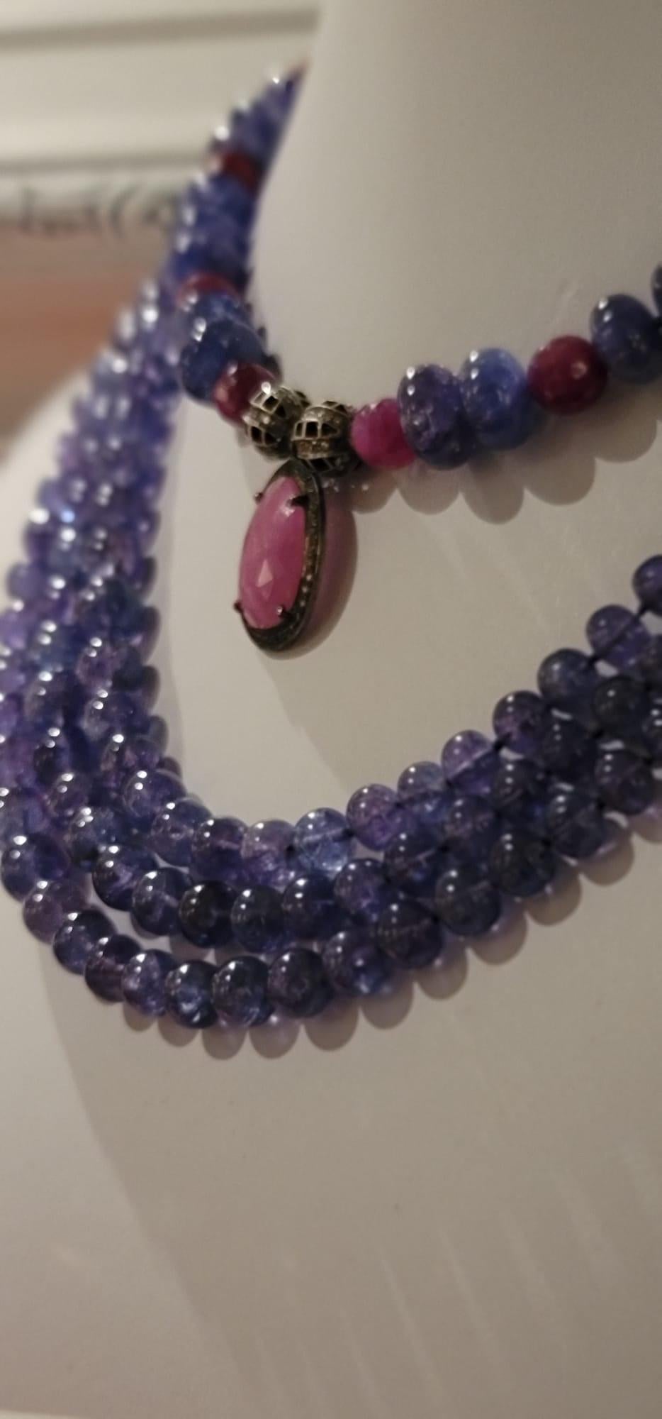 One-of-a-Kind

Tanzanite, Ruby, and diamond necklace. If not the holy trinity,close.
Polished  tanzanite alternates with radiant faceted rubies in a richly colored necklace anchored by two diamond beads that surround a diamond-encrusted faceted