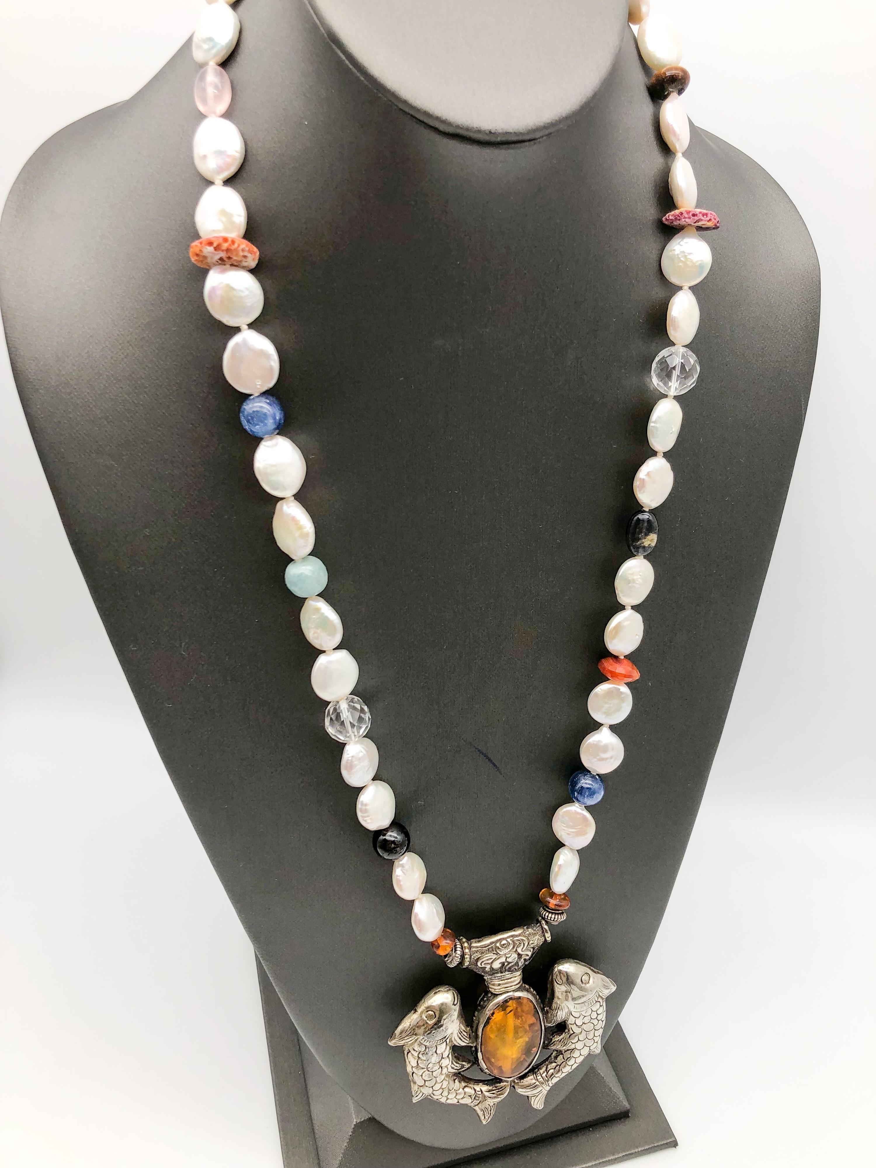 One-of-a-Kind
Sparkling Freshwater Pearl long necklace. The Coin Pearls are spaced with assorted 10mm Gemstone beads. 
Featuring Sterling Silver pendant Tibetan Auspicious symbol 