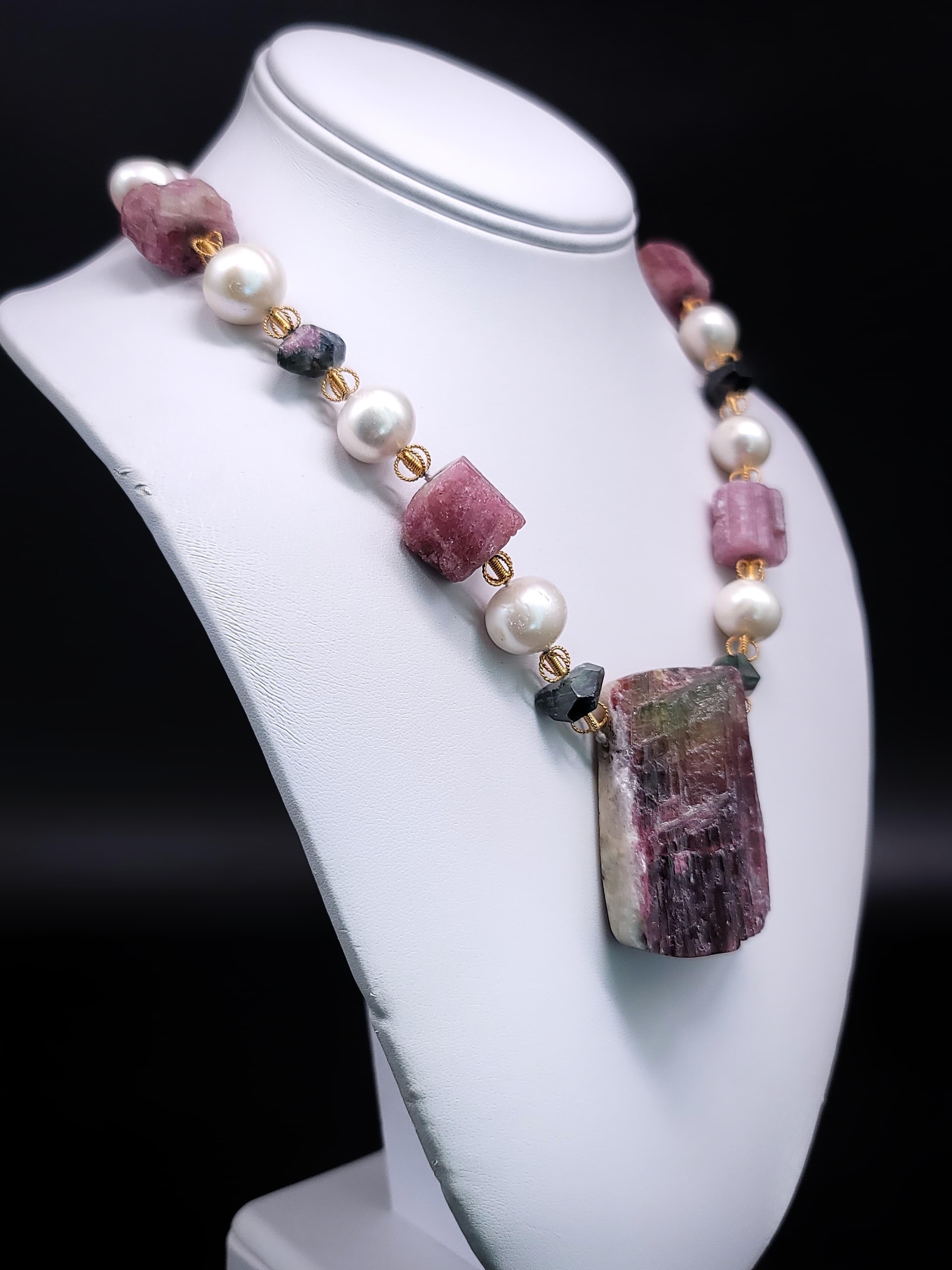 
Elevate your style with our one-of-a-kind Tourmaline Specimen Stone Pendant Necklace. This captivating piece seamlessly blends bold design with intricate details, making it a unique addition to your jewelry collection.

The focal point of this