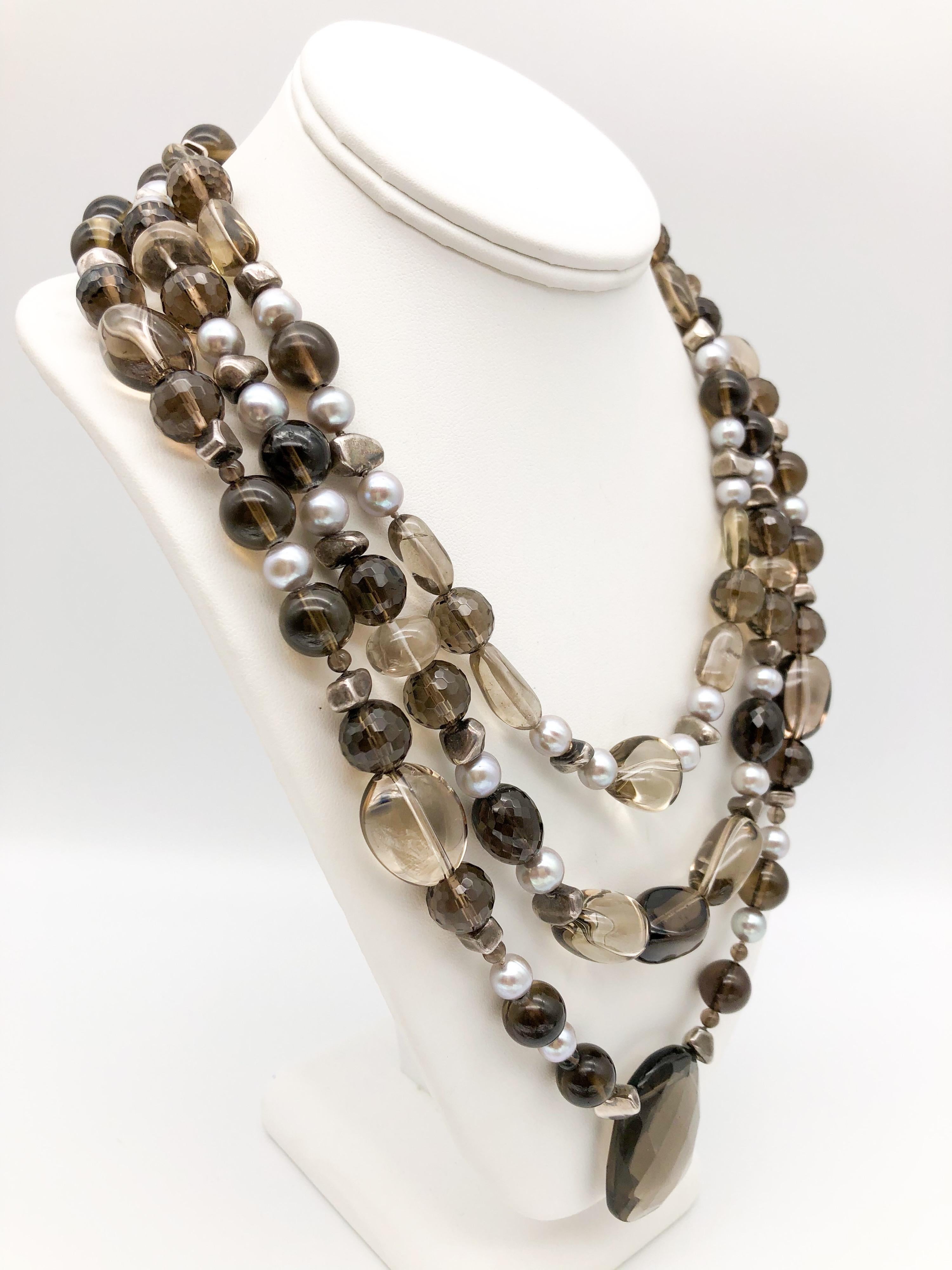 One-of-a-Kind
Three-strand Whiskey Quartz faceted and polished beads sparkles amidst the grey freshwater pearls and the sterling silver spacers. Three sizes and shapes of Quartz to create a graduated matinee length. The necklace is finished with a