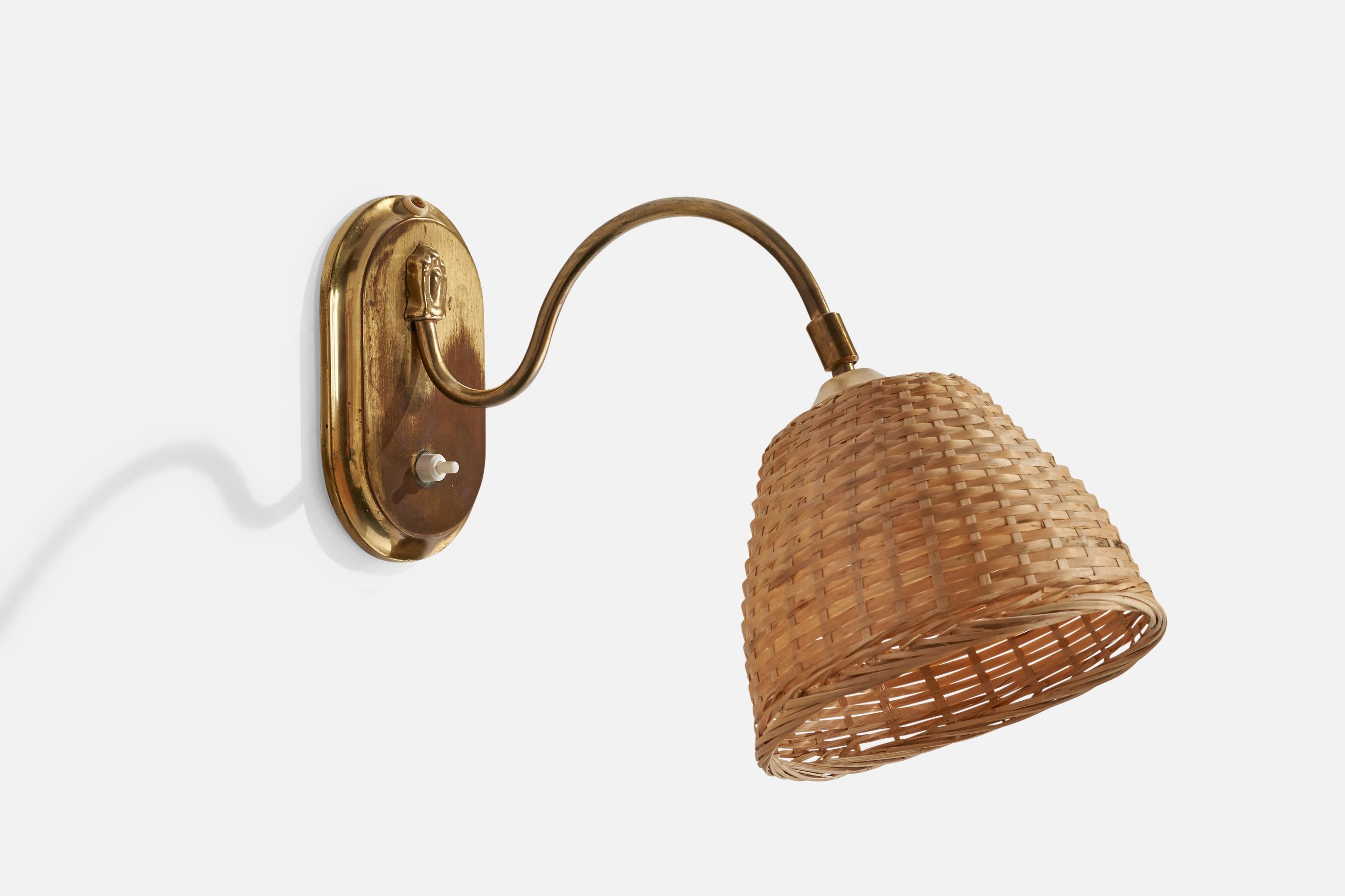 An adjustable brass and rattan wall light designed and produced by AJH, Sweden, 1940s.

Overall Dimensions (inches): 6.5”  H x 7”  W x 14.75” D
Back Plate Dimensions (inches): 6.5” H x 4.25” W x .75”  D
Bulb Specifications: E-26 Bulb
Number of