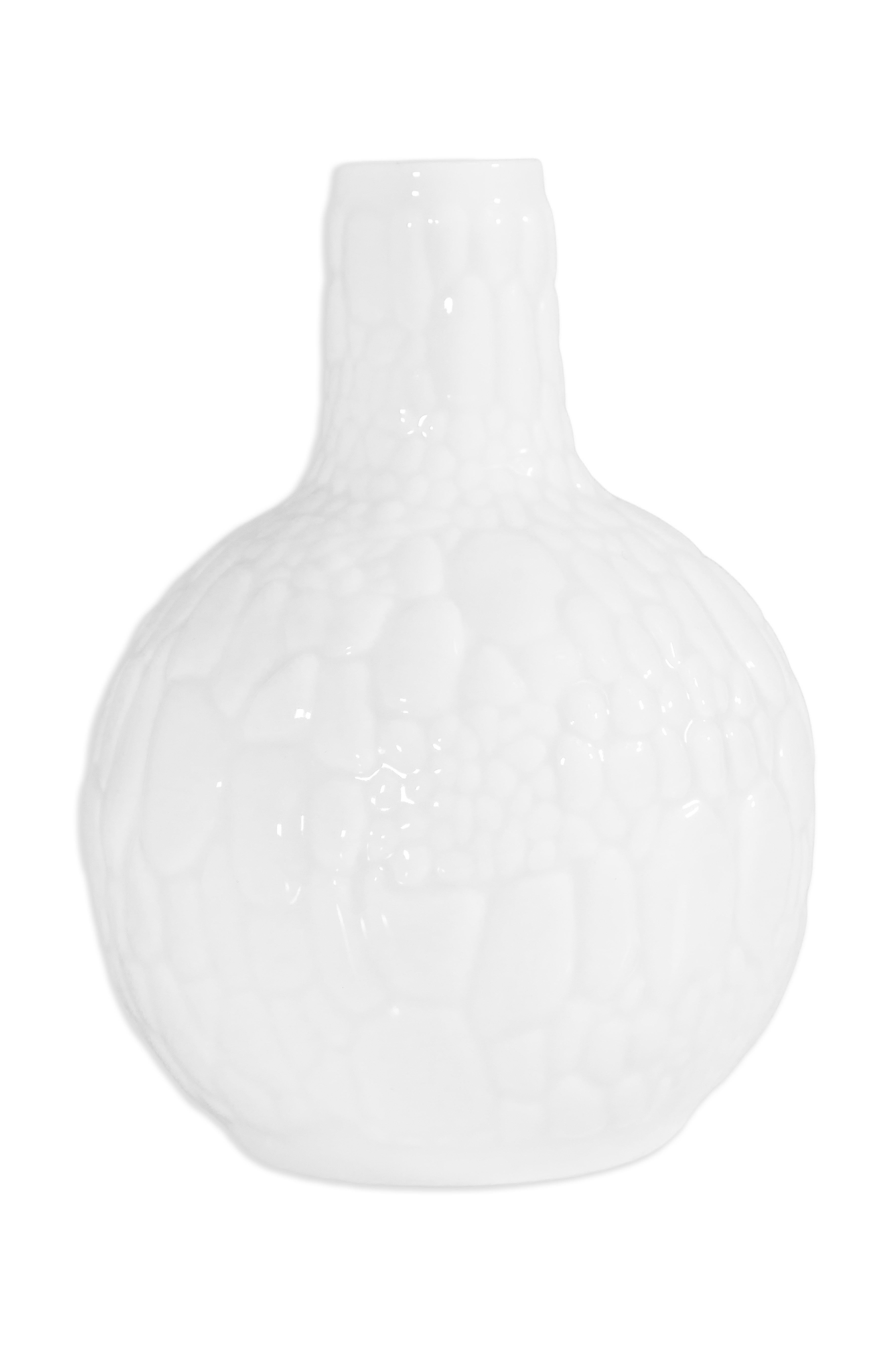 A sculptural Ak Kaiser German Op Art biscuit porcelain vase from the 1970s, featuring a striking textured surface reminiscent of natural rock formations in a glossy white glaze. The bulbous body gracefully tapers to a slender neck, highlighting the