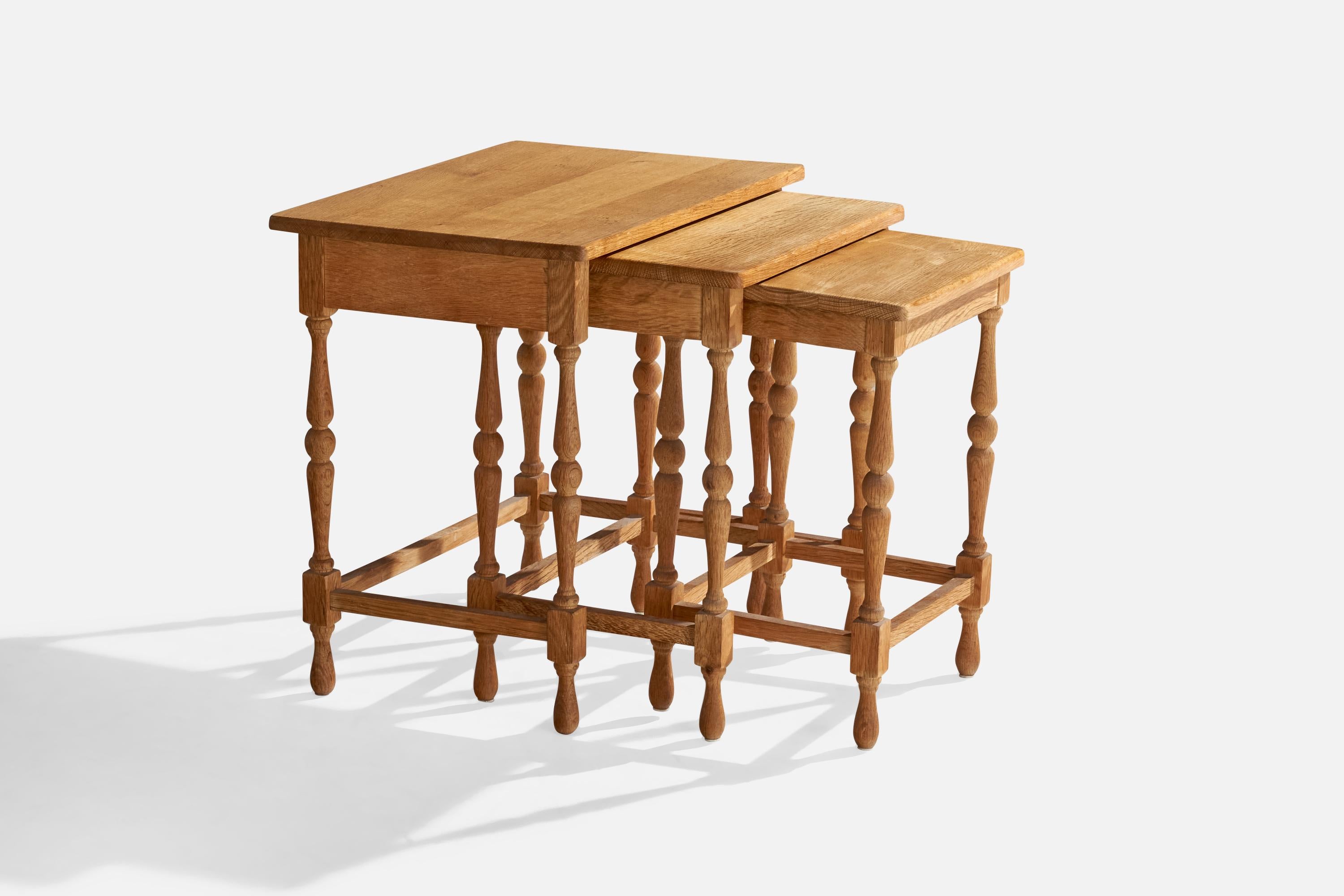 A set of 3 oak nesting tables produced by AK, Odense, Denmark, 1967.

Dimensions of smallest table: 19