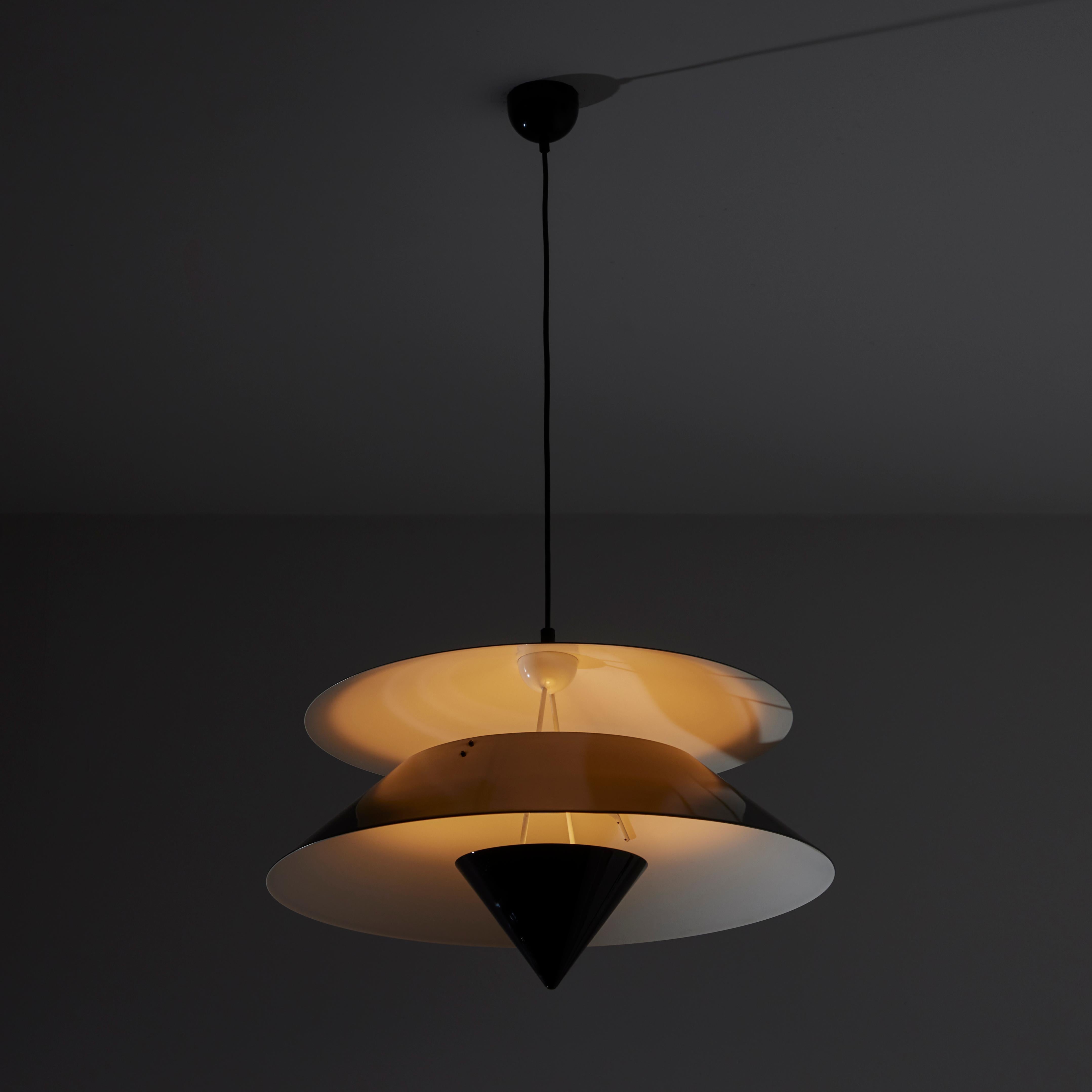 'Akaari' Ceiling Light by Vico Magistretti for Oluce. Designed and manufactured in Italy, circa the 1980s. The Akaari pendant features three tiered glossy black diffusers. The bottom cone diffuser allows the light source to reflcet back upwards but