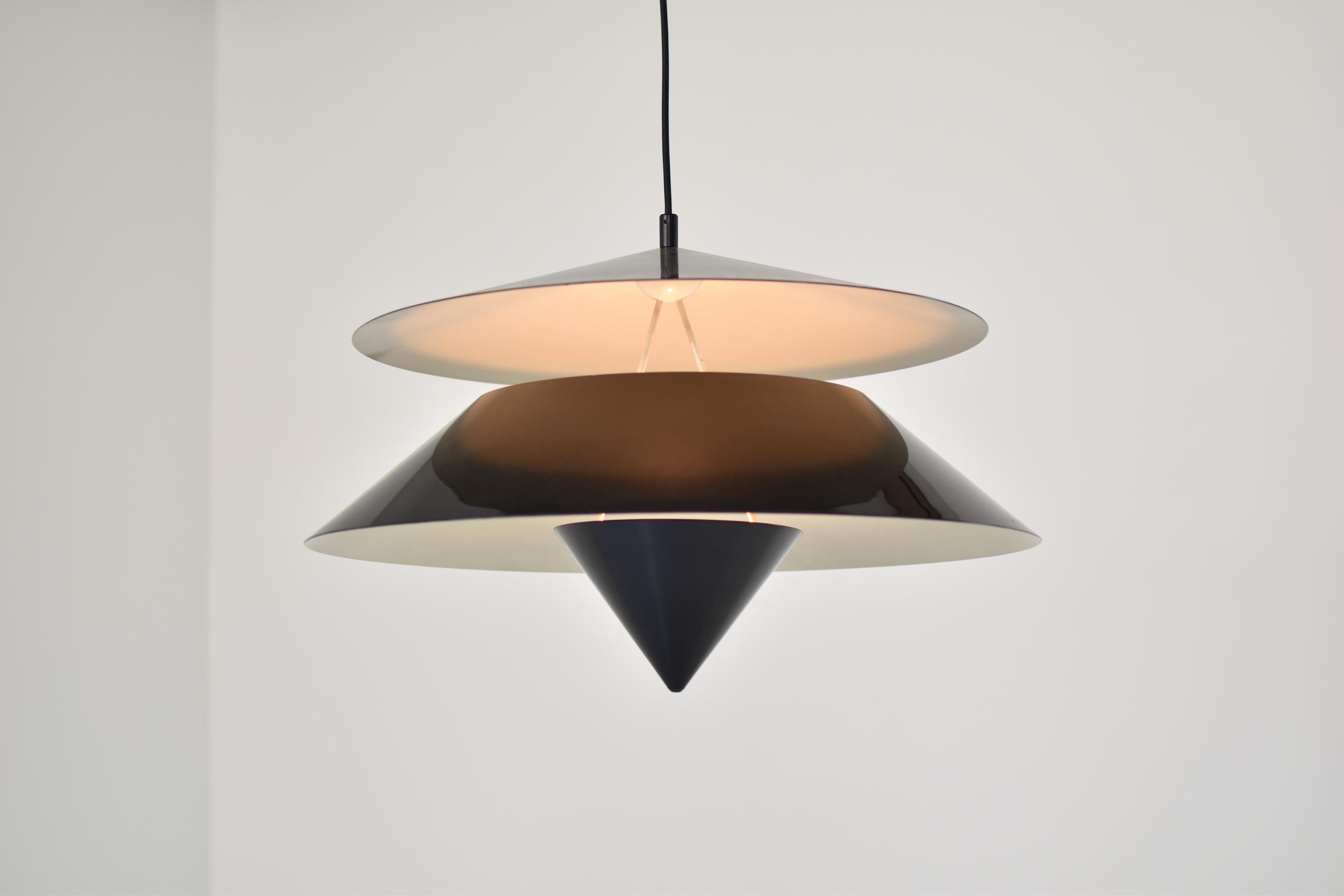 Rare ‘Akaari’ pendant by Vico Magistretti for Oluce, Italy, 1950s. This Modernist pendant is made out of black lacquered aluminum and metal. Provides uplight and downlight. Original canopy. Labeled!
