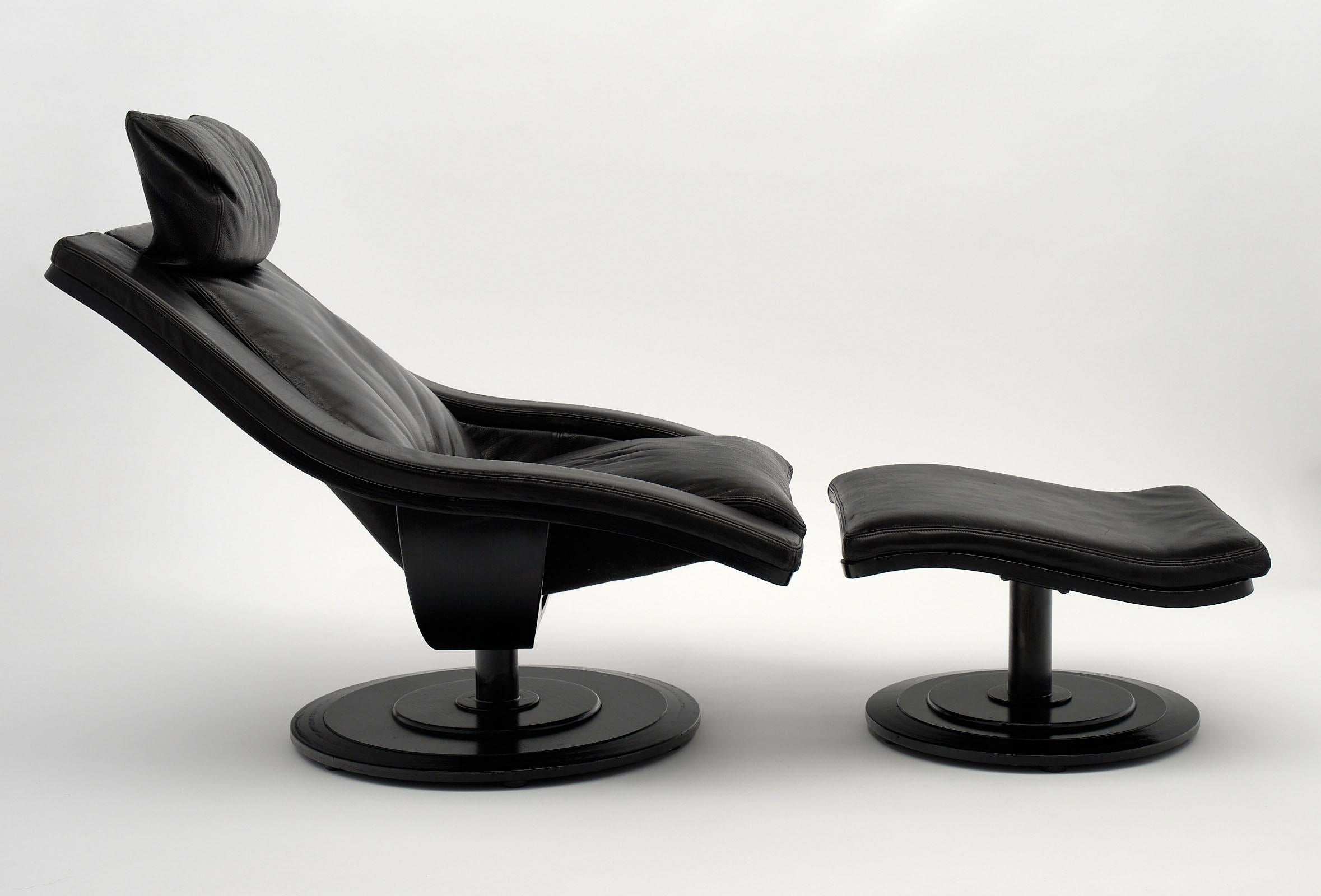 Akamura & Marquadsen for Nelo armchair, black leather armchair and ottoman with swiveling capabilities. The spheric black lacquered bases support this unique piece. They are signed. The listed dimensions are for the chair. The added depth with the