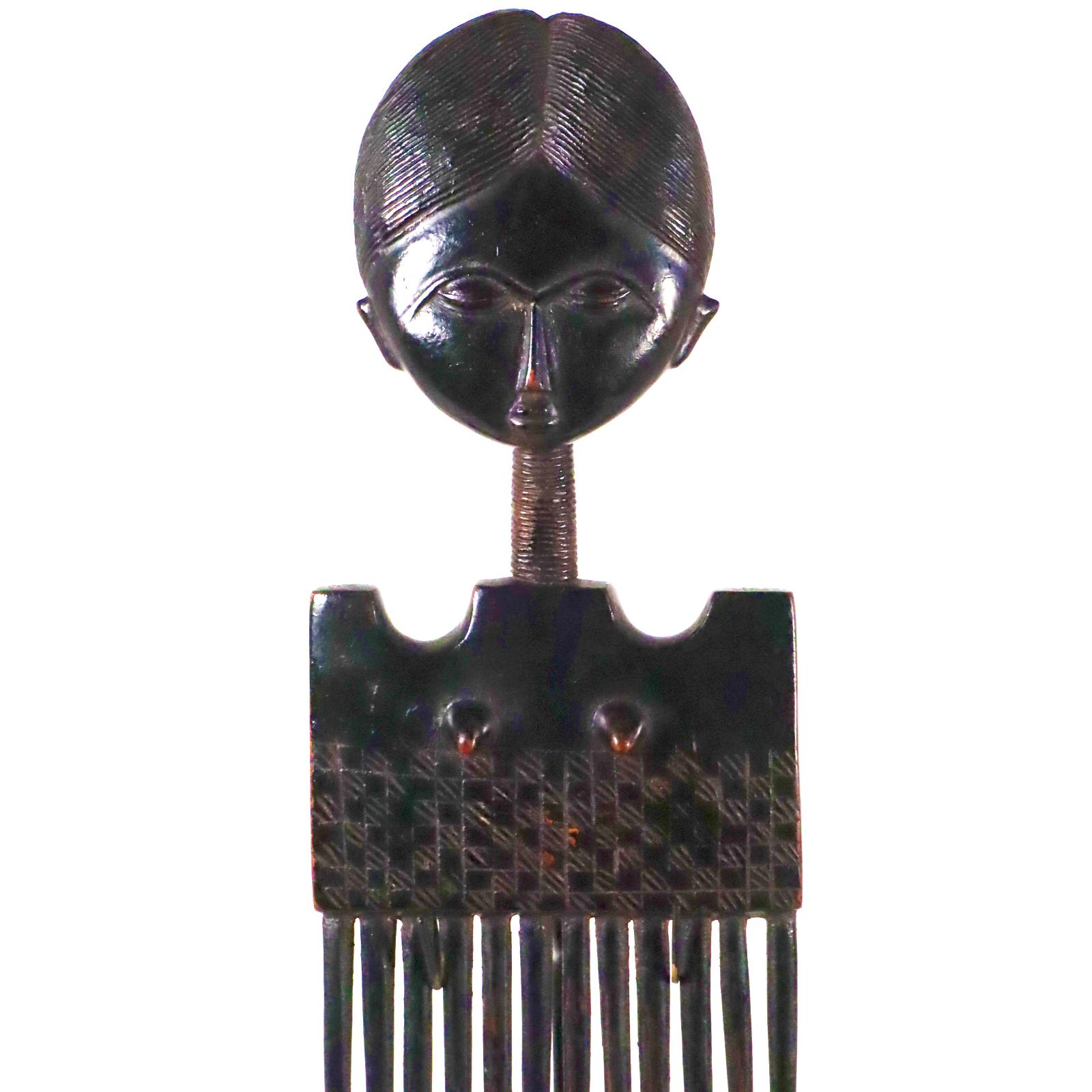 A magnificent hair ornament or comb from the Akan Ashanti (var. Asante) people of Ghana. Most likely created in the mid-20th century, prior to 1970. Carved from hardwood covered with black pigment polished to a high sheen.
Provenance:
Mr. & Mrs.
