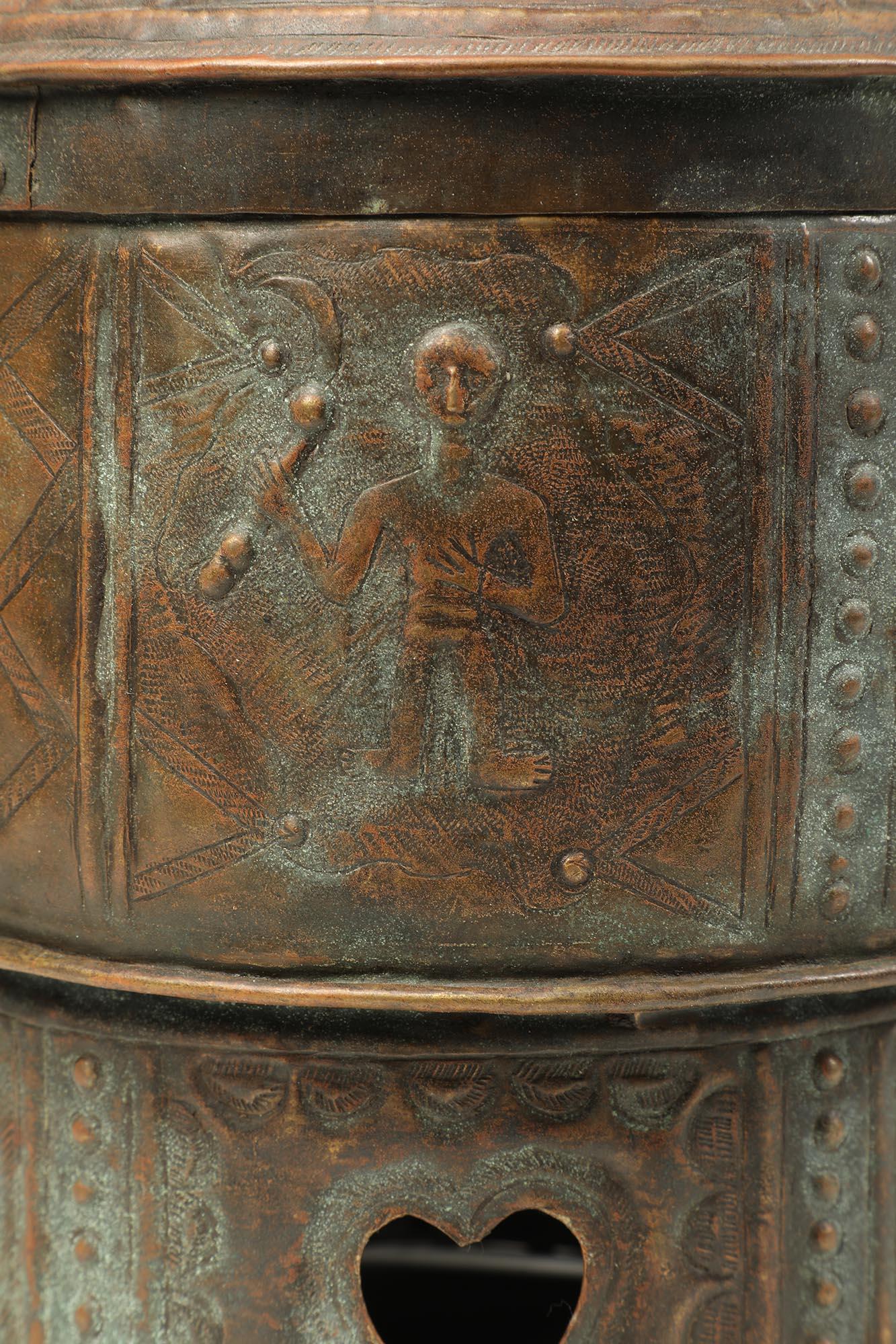 Fine repousse and cut sheet brass or bronze lidded treasure box from the Akan people of Ghana, West Africa, 20th century. Images include human figures, sandals, swords, and animals. These images relate to traditional Akan proverbs and symbolism.