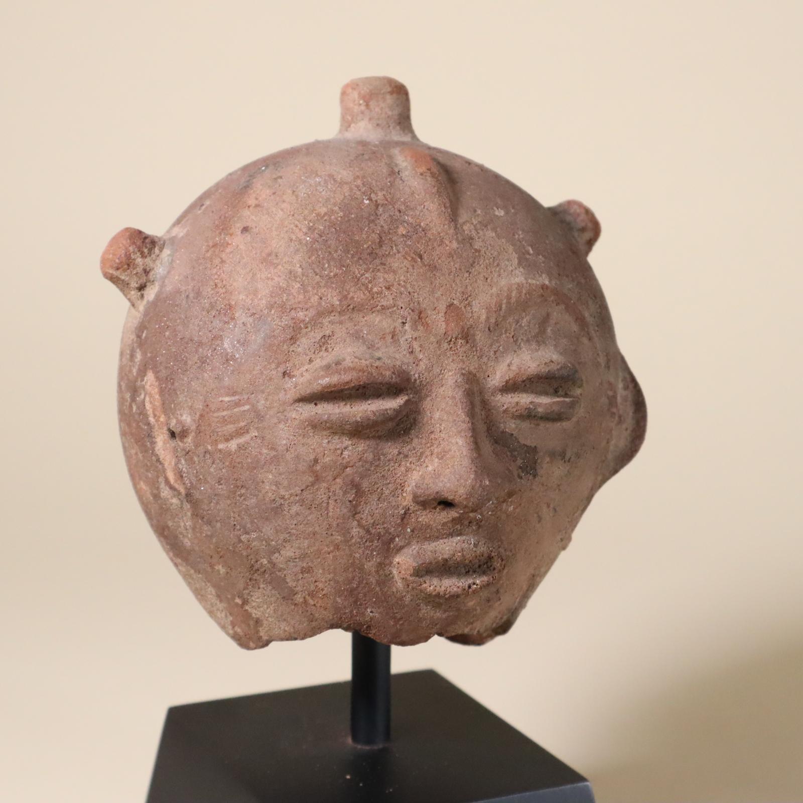 Store closing March 31. Here is another type of earthenware or terracotta portrait from the Akan people of Ghana. 19th century or earlier. 
This one globular, with three raised coils of hair and a raised crescent shape on back of head. Finely