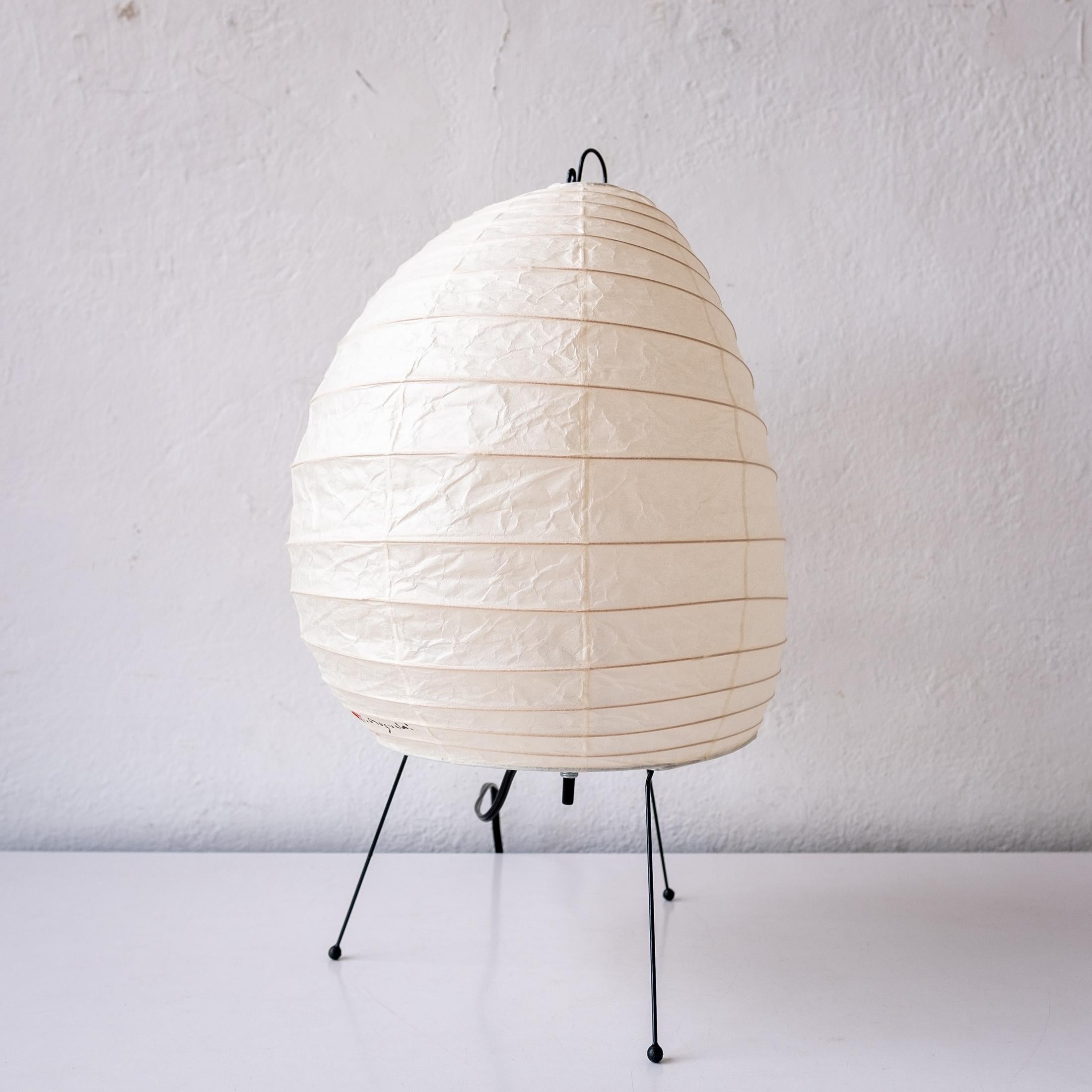 Akari light sculpture by Isamu Noguchi. The shade is made from washi paper and bamboo ribs with Noguchi Akari sun and moon stamp, signature and marked Japan. Designed by Noguchi in the 1950s, this is an unused 1990s example, still in the original