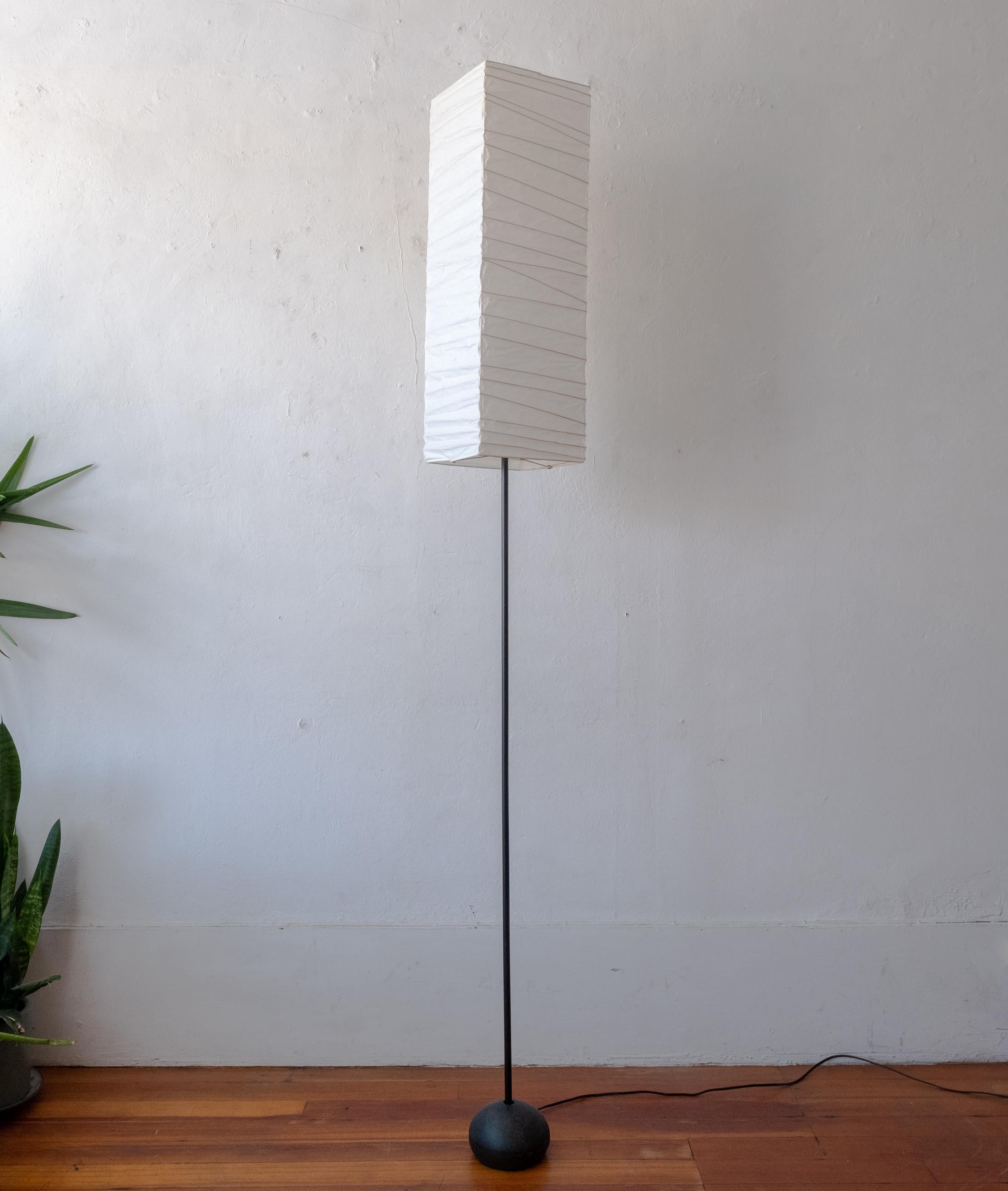 Akari light sculpture by Isamu Noguchi. Iron base. The shade is made from washi paper and bamboo ribs with Noguchi Akari sun and moon stamp, signature and marked Japan. Designed by Noguchi in the 1950s, this is an example from the 1980s. Handmade by