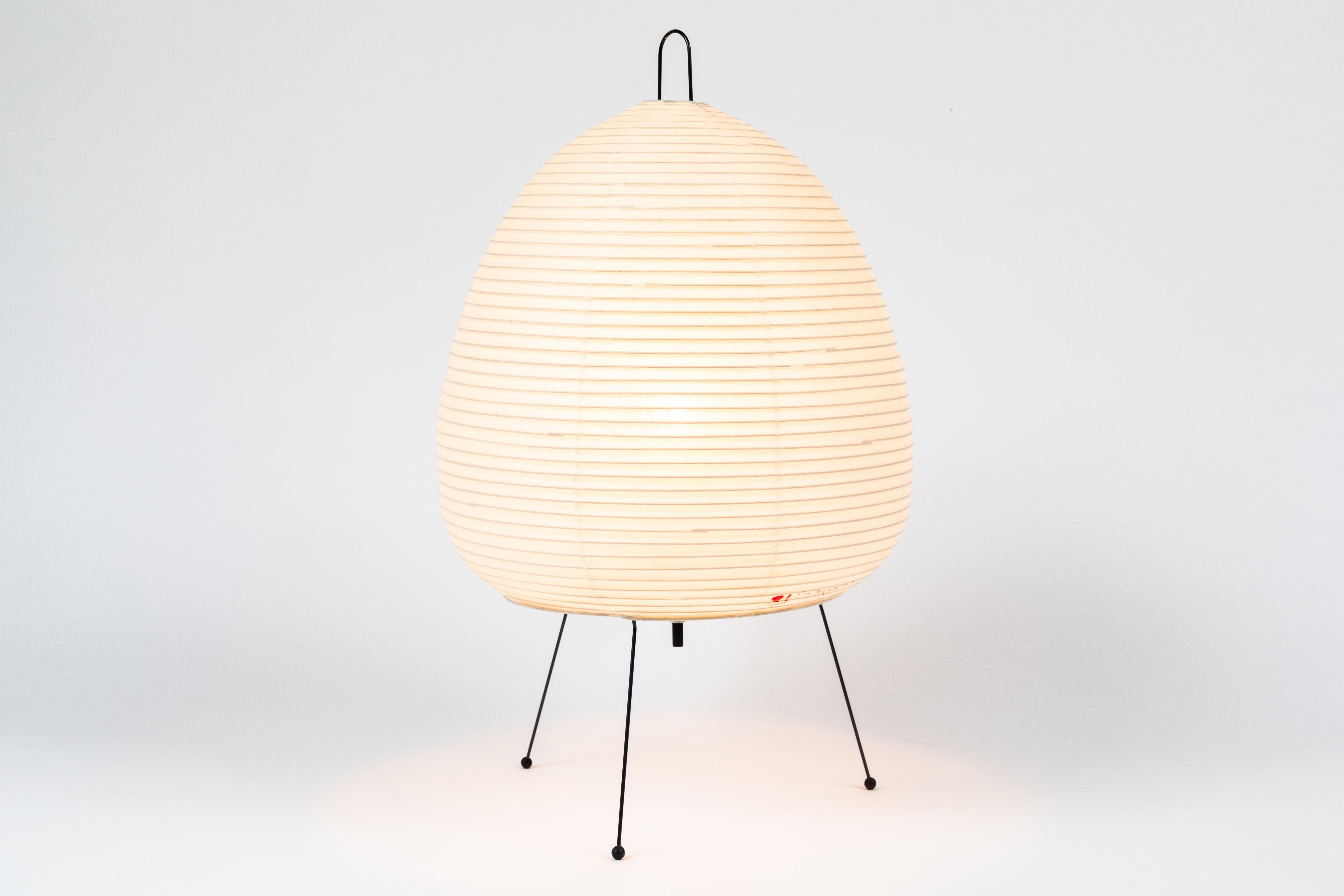 Akari model 1A light sculpture by Isamu Noguchi. The shade is made from handmade washi paper and bamboo ribs with Noguchi Akari manufacturer's stamp. Akari light sculptures by Isamu Noguchi are considered icons of 1950s modern design. Designed by