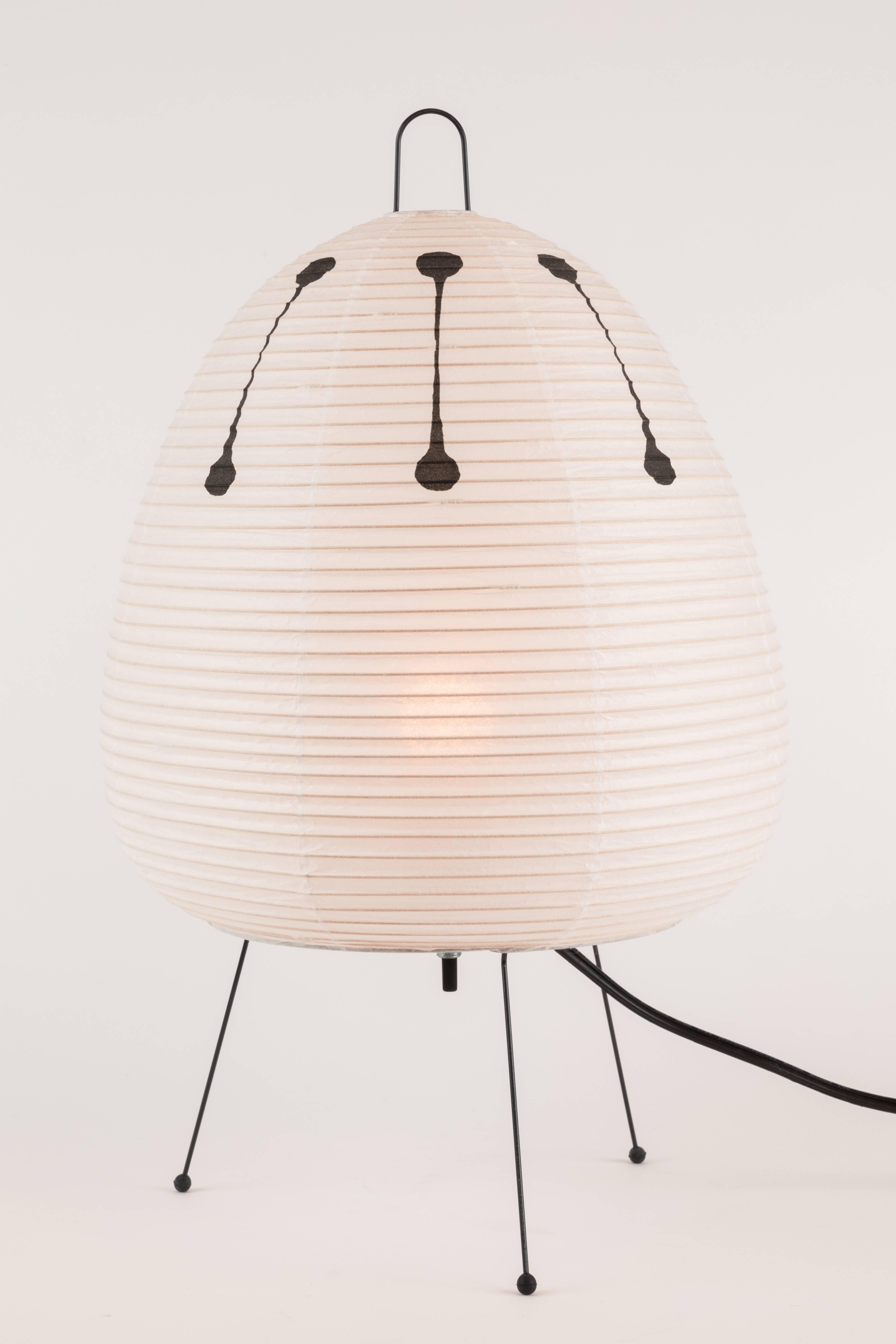 Akari model 1AD light sculpture by Isamu Noguchi. The shade is made from handmade washi paper and bamboo ribs with Noguchi Akari manufacturer's stamp. Akari light sculptures by Isamu Noguchi are considered icons of 1950s modern design. Designed by