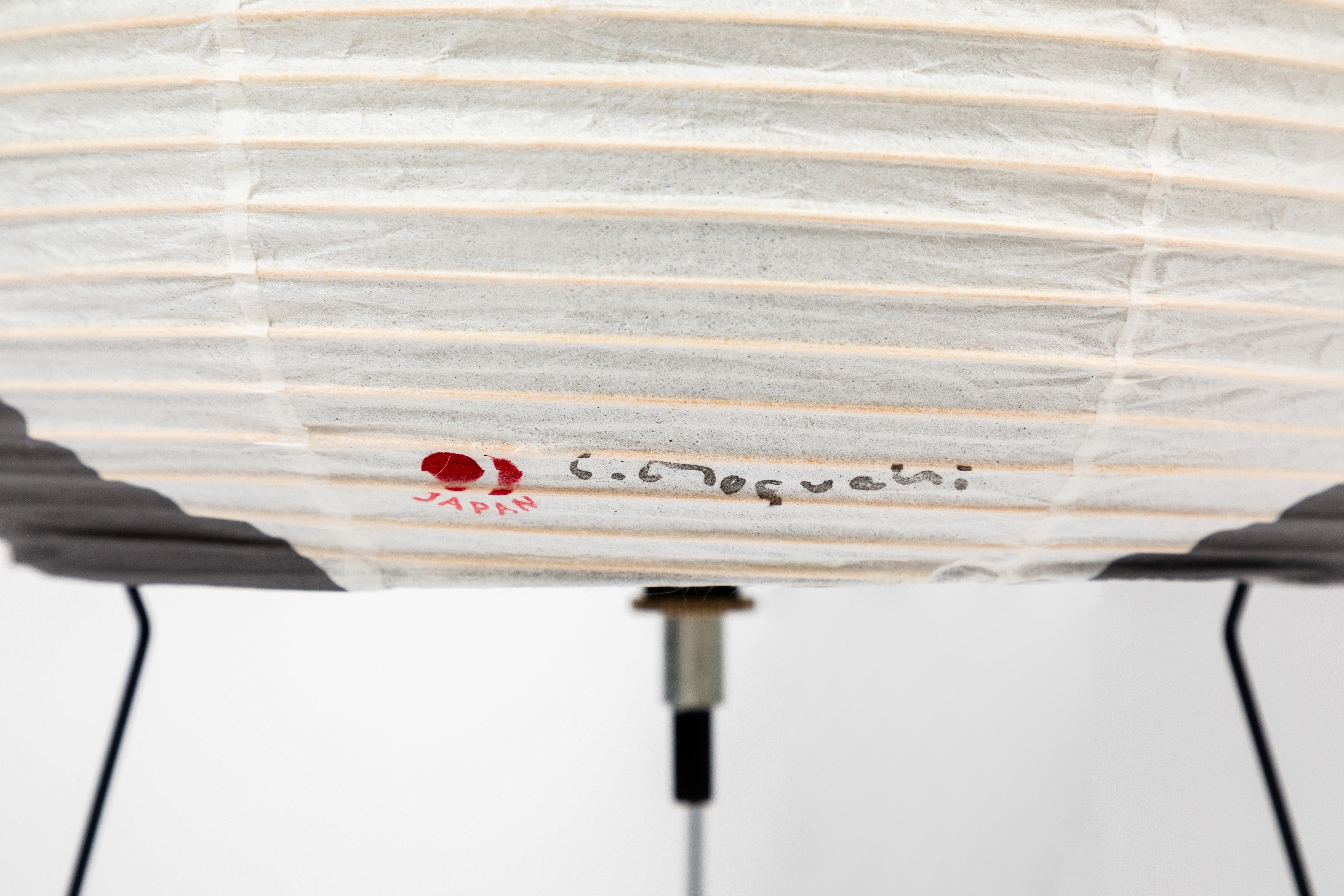 Akari model 1AG light sculpture by Isamu Noguchi. The shade is made from handmade washi paper, ink and bamboo ribs with the original Noguchi Akari manufacturer's stamp. Akari light sculptures by Isamu Noguchi are considered icons of 1950s modern