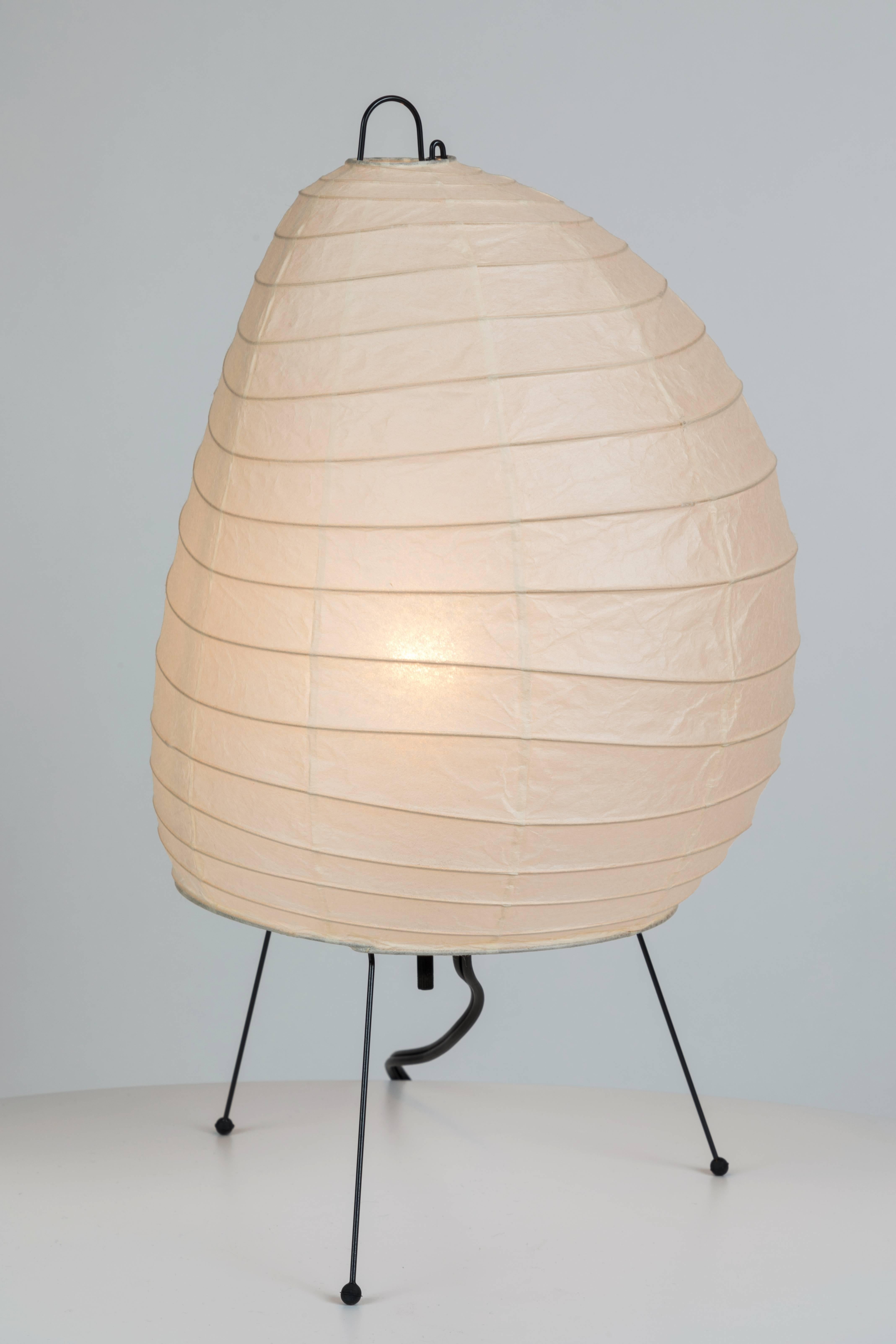 Akari Model 1N light sculpture by Isamu Noguchi. The shade is made from handmade washi paper and bamboo ribs with Noguchi Akari manufacturer's stamp. Akari light sculptures by Isamu Noguchi are considered icons of 1950s modern design. Designed by