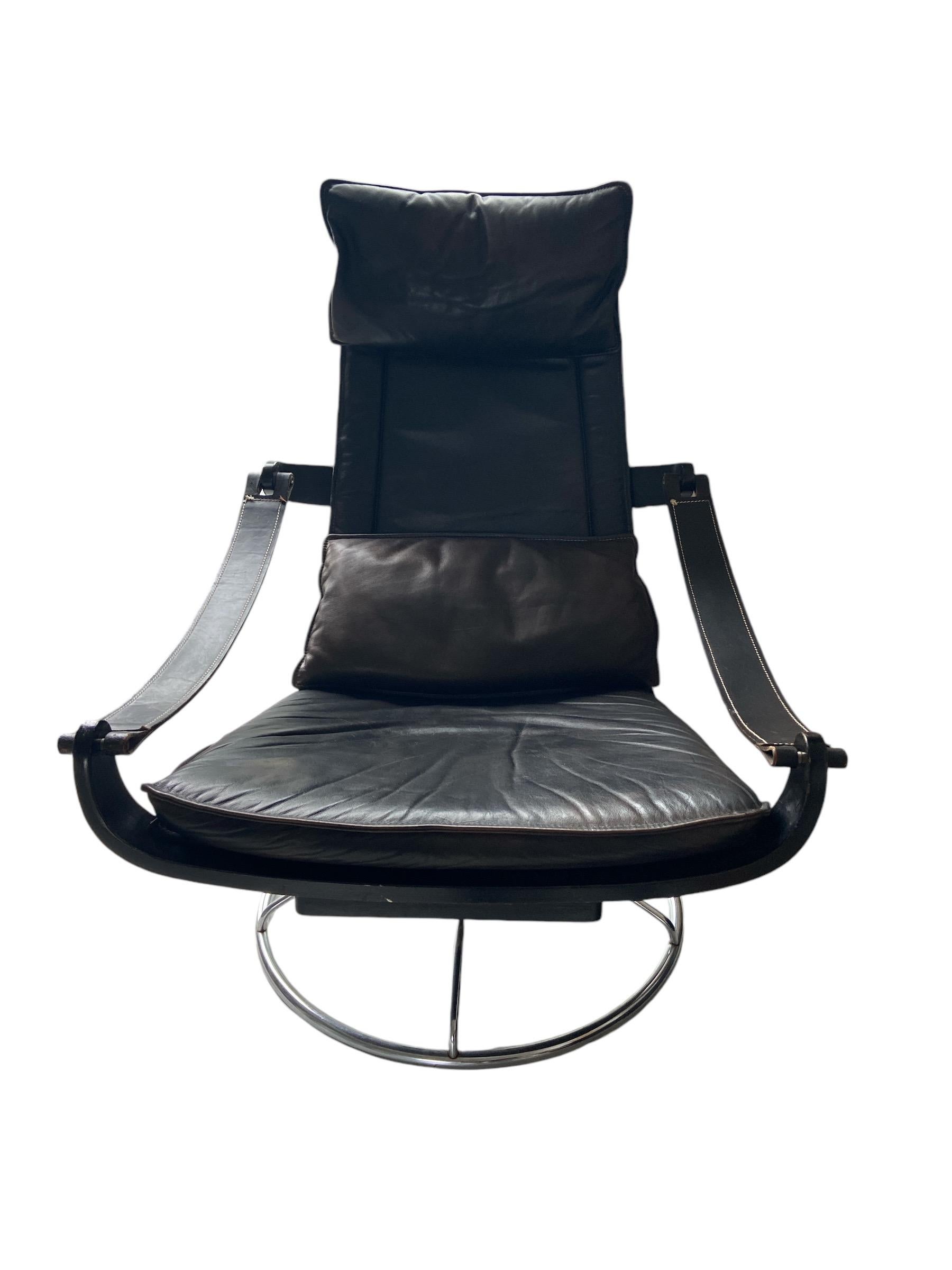 Swivel chair by the Swedish designer Ake Fribytter for NELO in black leather.
There is a head pillow and one in the back. With a level you can sit  the more backwards; a very comfortable chair! 
  