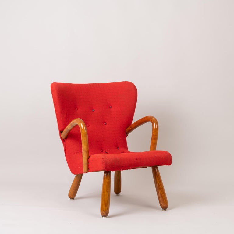 'Åke' clam chair or Muslingestol by IKEA, Sweden. The armchair is designed and manufactured during early to mid-1950s and is a good example of the Scandinavian Modern design. It is in original condition with some wear to the fabric. The padding