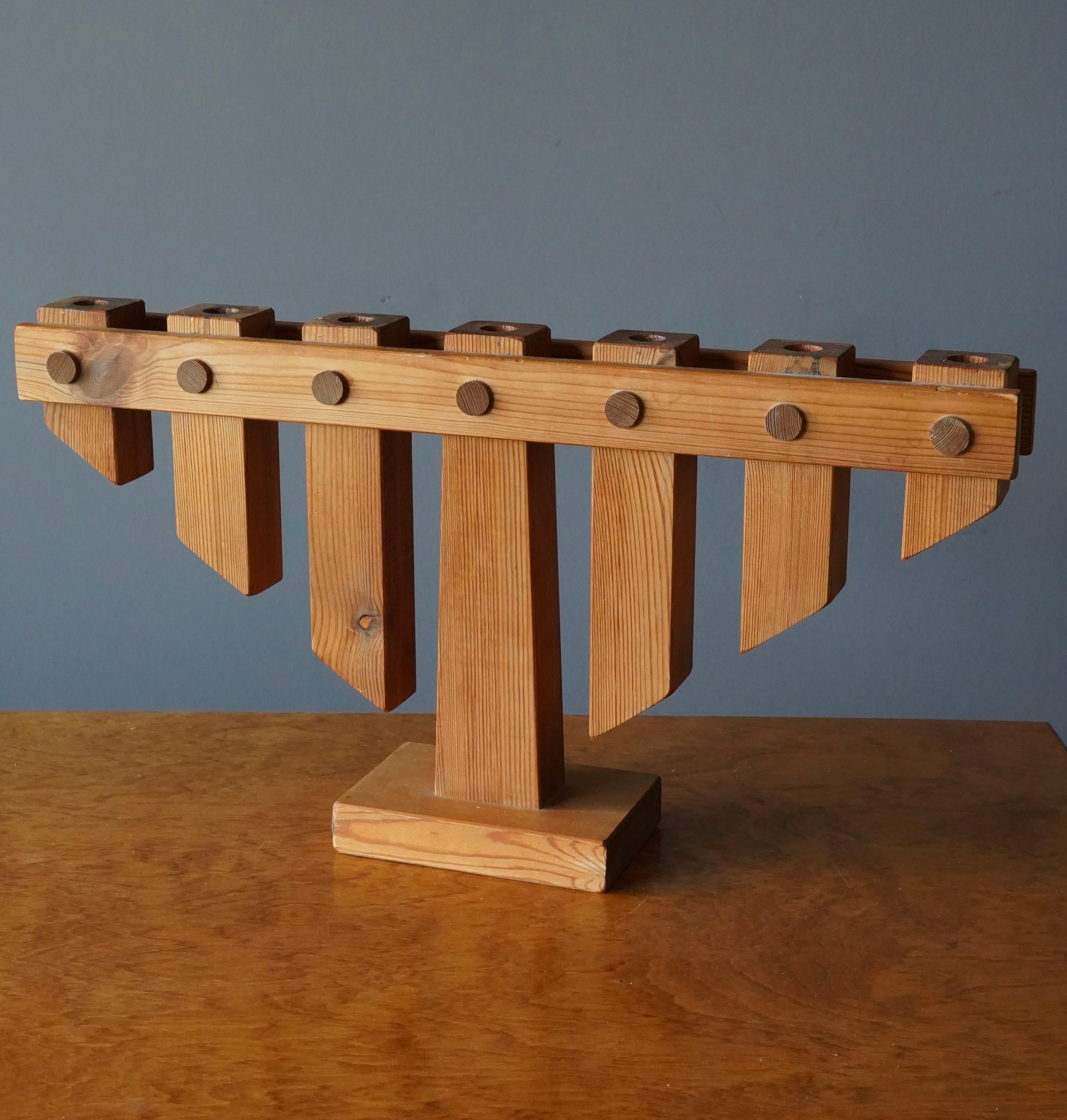 A sizable candelabra, in Solid Pine, produced in Sweden, 1970s. By Akeba Sweden. With branded mark.