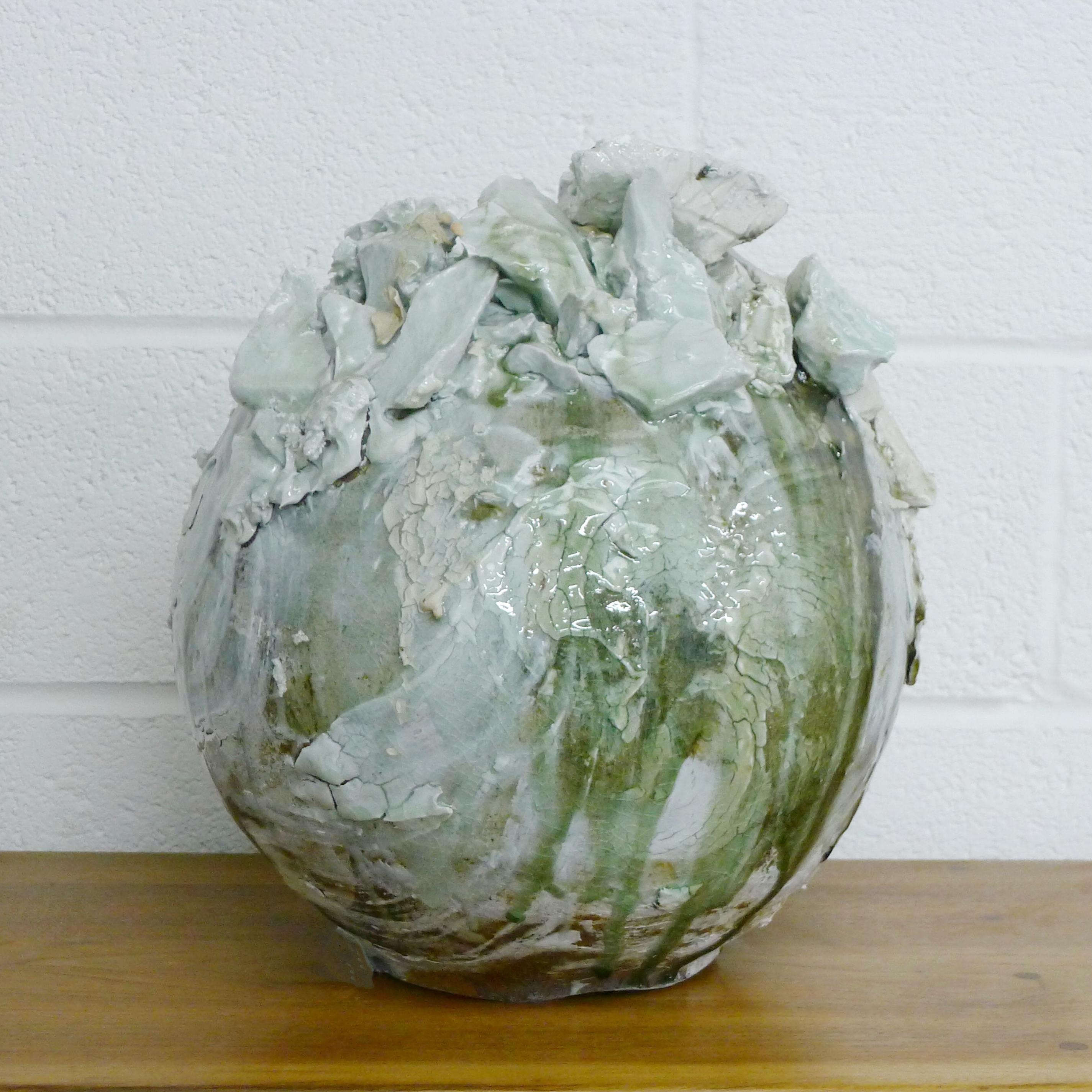 Akiko Hirai (born 1970)
Moon Jar
Grogged stoneware, large rugged porcelain deposits over white and black slips under running pale blue and green glazes, areas of dry flaked and slip to surface
43cm high, 37cm diameter

Condition: Appears to be in