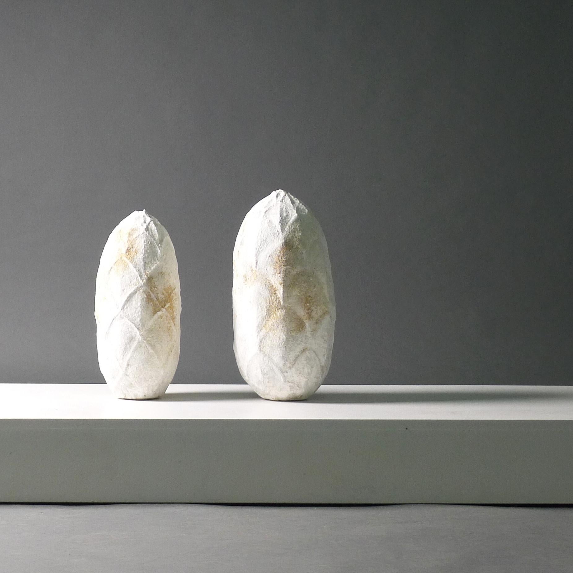 Akiko Hirai (born 1970)
Two Cocoon vessels in stoneware, dry cracked and crawling white slip over a mottled brown body, tall enclosed ovoid form with facetted sides
the largest 42cm high, 19cm diameter
Price is for both vessels.