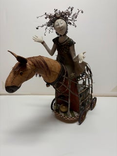“Lady On Horse Carrying Child Sculpture”