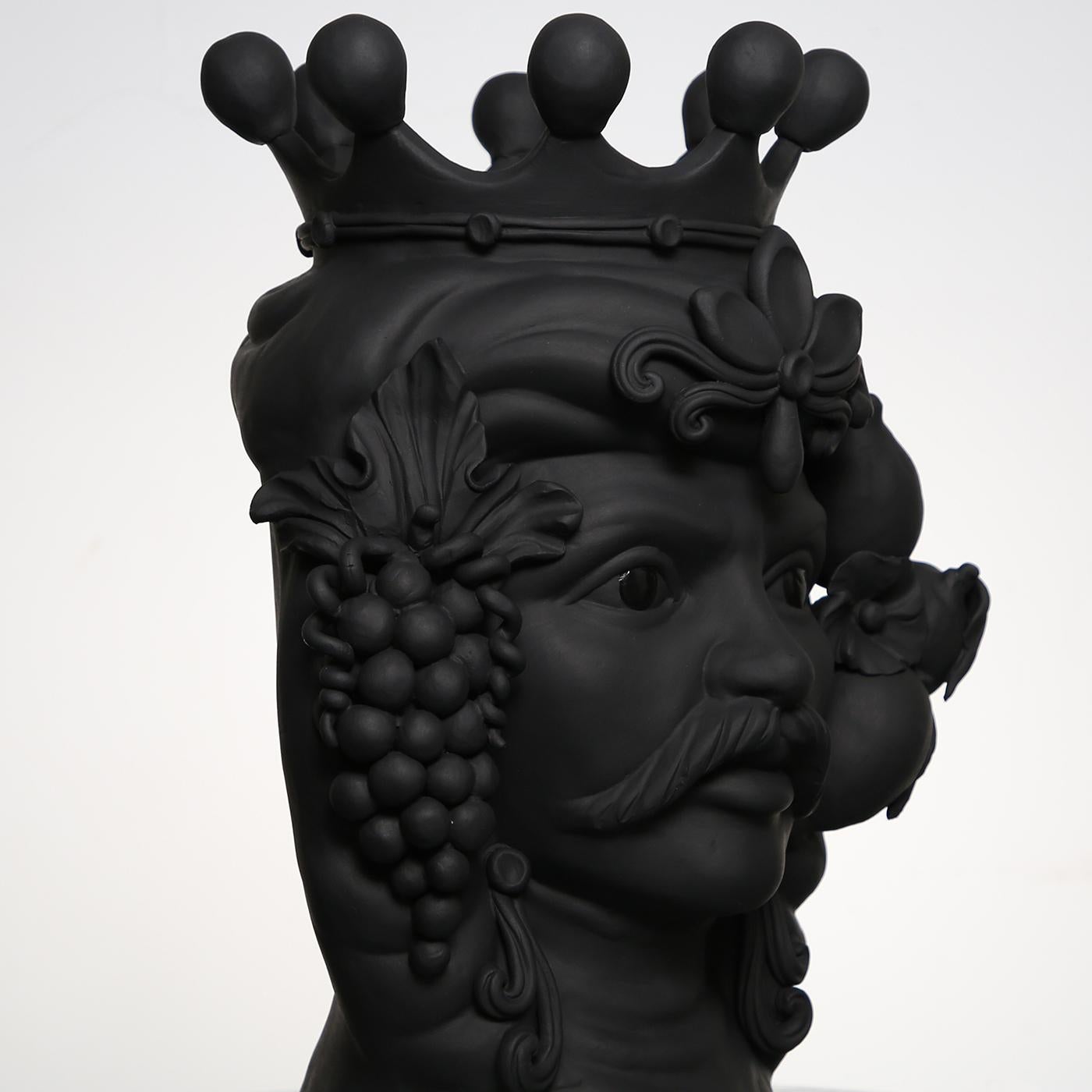This anthropomorphic vase is made entirely by hand and painted in a black matte monochrome tint, rich in natural pigments and resin binders that provide intense color depth. Only the eyes are glazed so they stand out, emphasizing the beauty of the
