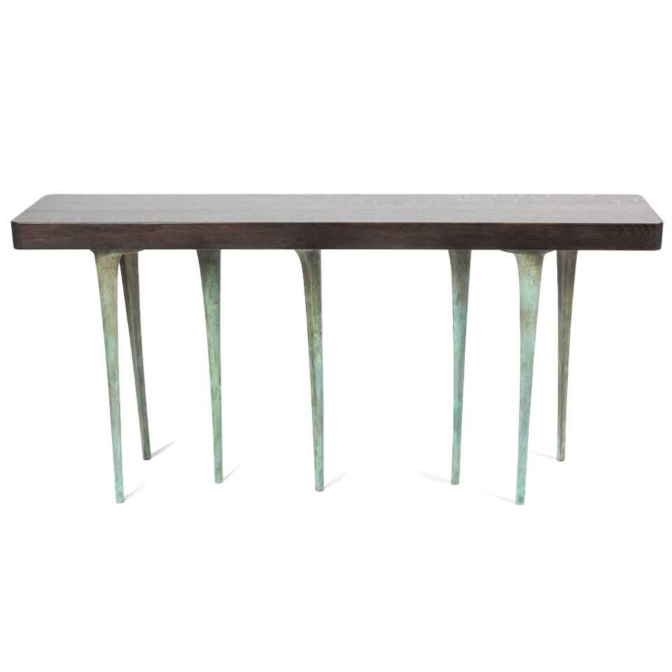 The elegant design of the thicket console table pairs fully customizable solid wood tabletops with slender cast aluminium legs. The tabletops are made to order and are available in an extensive range of wood species and finishes, including an option