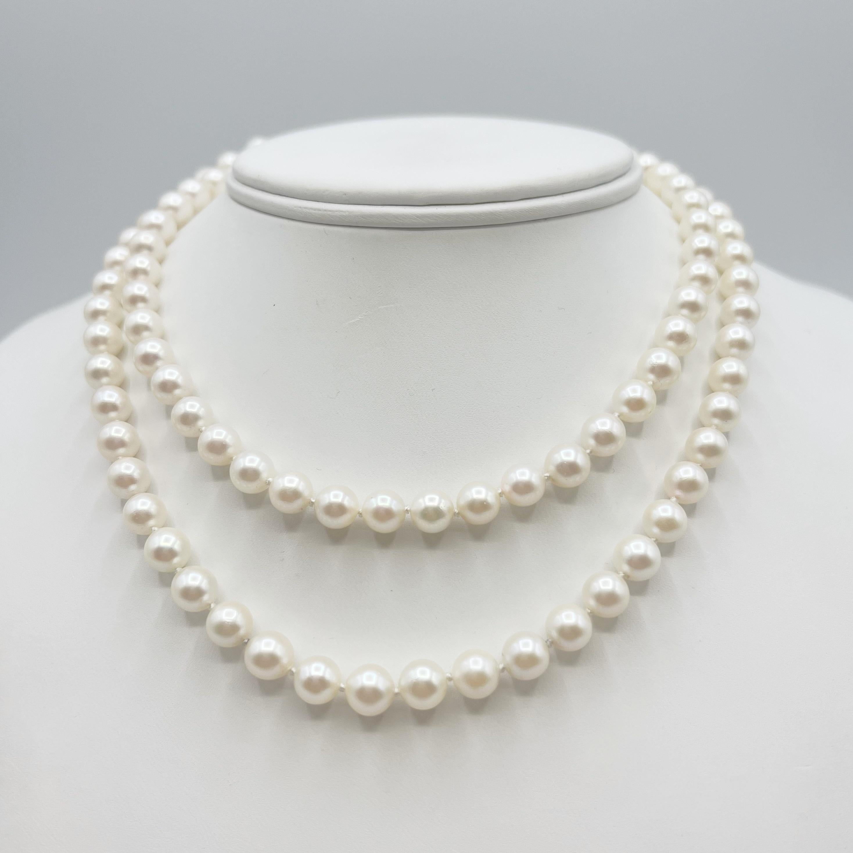 These beautiful pearls are a white luster measuring 7mm round. They are cultured Japanese cultured saltwater Akoya pearls. The clasp is 14 Karat gold with opals forming a flower design that can be worn several different ways (see photos). The stand